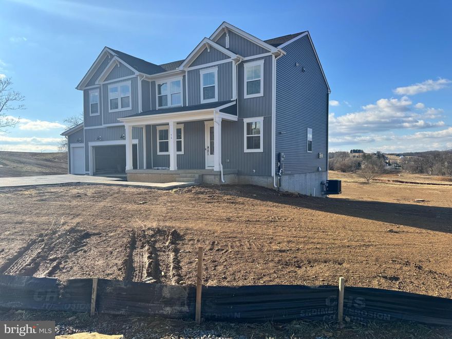 This stunning home is almost complete and will be move in ready March 2025! Welcome to Estates of Tuscarora, a brand-new community offering 1+ acre homesites within close proximity to commuter routes, shopping, parks, and Historic Downtown Martinsburg!  The Baltic 2-story colonial home on 1.78 acres located on Homesite #2, includes a 3-car garage, 5-bedrooms, and 4 bathrooms.  This home blends timeless Classic interior design with modern convenience! Offering an open floor plan, this home is perfect for both comfortable living and entertaining.  The inviting family room with stone front fireplace is seamlessly connected to the kitchen and casual dining area.  The well-appointed gourmet kitchen features stacked (to the ceiling)- soft close cabinets, GE Profile Stainless Steel appliances with range, hood vent, built-in wall oven and microwave, complete with a spacious island with quartz countertops.  This home includes a home office an extra bedroom and full bath on the main level, ideal for guests, in-laws, or a flexible living space! The upstairs includes a generous loft area, 3 secondary bedrooms, laundry room and spacious Primary Bedroom.  The Primary Bedroom boasts a feature wall with trim, tray ceiling and luxury bath complete with a frameless shower door and free-standing soaking tub. The finished basement recreation room and full bath complete this home on a walk out homesite.  Imagine unwinding on the covered deck, a perfect outdoor retreat designed for relaxation and enjoyment, whether sipping your morning coffee as the sun rises, hosting a summer barbecue, or cozying up with a book during a gentle rain, this versatile space offers endless possibilities. This home is a perfect blend of charm, functionality, and space, designed to meet all your needs. Don’t miss the opportunity to make this remarkable home your own!  Call and schedule your personalized appointment today! Ask about our closing cost assistance with the use of Khovnanian American Mortgage **Photos are virtually staged renderings and may not reflect the current finishes for the home.  See Sales Consultant for more information**