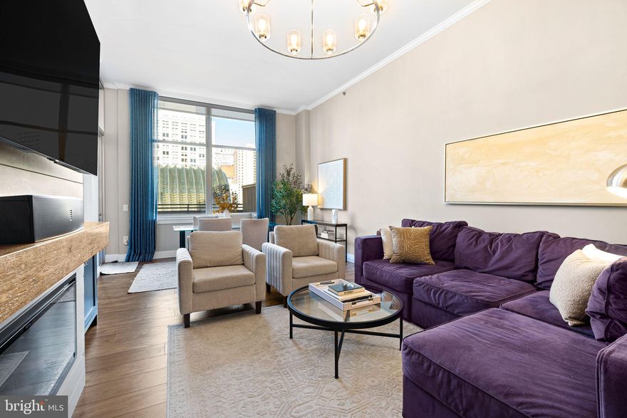 A rare find - one of only three private residences on the coveted amenities floor of the Symphony House, this exclusive unit features unparalleled private outdoor space with skyline views.
This one of a kind residence is a must see to believe. Tastefully renovated with designer-selected finishes, this home is warm and inviting, and sun-splashed with natural light. This oversized floor plan with soaring high ceilings is generously proportioned, offering nearly 1,000 square feet of living space. An open chef's kitchen with a full suite of stainless steel appliances and quartz counter tops, complementing warm cherry cabinetry, flows effortlessly into an open dining area, allowing entertaining with ease. The living room easily accommodates large furniture sets in a number of combinations with ease, and features a custom entertainment center with built-ins and fireplace. Oversized windows provide incredible views of downtown. Off the living and dining room area, find a beautifully renovated full bath with spa-like walk-in glass shower, vanity, and an incredibly spacious linen closet. Find your own in unit laundry in a separate hall closet, in additional to a pantry storage closet. A fantastic amount of closets for a one bedroom. Enter into the bedroom with soaring ceilings, a huge walk in closet, and window bench seating. A truly standout feature of this unit is it's private patio, which offers an additional 500 square feet of living space outdoors. Overlooking the stunning neighboring arch of the Kimmel Center, you are immersed in the skyline--you can see the Eagles parade down Broad Street from your own terrace!
This unit also features it's own covered parking space in the attached garage with interior access, and a generously sized private storage unit on the building's storage floor.
The building's 8th floor features only three select units, with their own private, secured entry, as it is home to all of the luxurious amenities the building has to offer, including: fitness center, library, lounge and meeting room, catering and hosting facilities, and the beautiful indoor swimming pool and sauna with its two outside north and south facing sun decks. The incredibly well maintained building features 24 hour doorman/security and has top-rated resident satisfaction.
