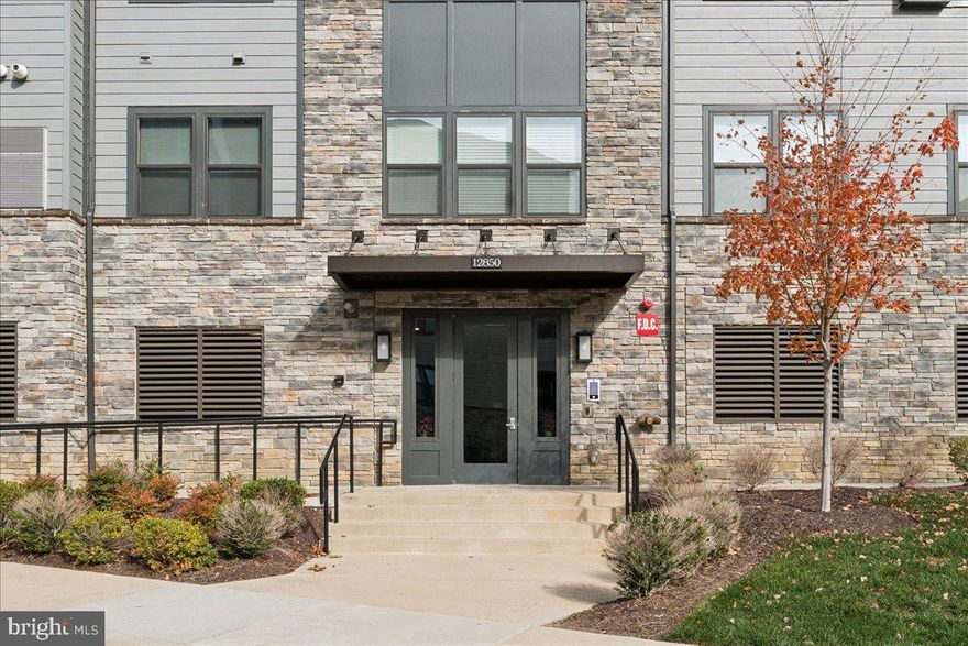 Live, work, and thrive in the heart of Herndon’s Dulles Tech Corridor. Modern Comfort. Metro Access. Herndon’s Hidden Gem - Mosaic at Woodland Park Station. Nearly new and beautifully appointed, this two-bedroom, two-bath luxury condo with a spacious den (ideal for a hybrid workspace or guest suite) delivers the perfect balance of modern design and everyday convenience. Step inside to an open-concept layout with LVP flooring, quartz countertops, a massive center island, upgraded stainless steel appliances, and soft-close cabinetry—crafted for effortless entertaining and sleek daily living. The primary suite feels like a retreat, featuring dual closets and a spa-inspired bath with double vanities and a large walk-in shower. A private balcony offers a peaceful outdoor escape—perfect for morning coffee or evening unwind. This is where location meets lifestyle: walk to the Herndon-Monroe Silver Line Metro, Harris Teeter, and neighborhood favorites like Stone’s Cove, Kumo Sushi, and Woodland Park Crossing. Enjoy community walking trails, sports courts, playgrounds, and picnic areas, or head just two miles to Reston Town Center for dining, shopping, and nightlife. Located in the sought-after Fairfax County School District, this home is zoned for Coates Elementary, Carson Middle, and Westfield High School. Whether you’re a tech professional seeking a low-maintenance home near major employers, a frequent flyer craving quick Silver Line and Dulles Airport access, a move-down buyer looking for the ease of elevator access and walkable convenience without sacrificing modern style, or an investor/house-hacker drawn to strong rental demand and turnkey appeal—this condo checks every box: modern, move-in ready, and minutes to everything. Additional Neighborhood Highlights: Transit & access: Less than a mile to the Silver Line (Herndon & Innovation Center stations), with large park-and-ride garages and frequent Fairfax Connector service—easy commutes to Reston, Tysons, Arlington, and DC. The immediate area scores 65–74 on Walk Score (very walkable pocket within Woodland Park), with “good transit” and bikeable streets. Everyday convenience: Steps to Woodland Park Crossing (Harris Teeter, restaurants like Kumo Sushi, Stone’s Cove, Peter Chang). Job centers: In the Dulles Tech Corridor—near major tech/aerospace employers (AWS, Microsoft/LinkedIn, Google, Raytheon, Northrop Grumman, Leidos, CACI, BAE). Quick access to Dulles Airport and the VA-267/Route 28 interchange.