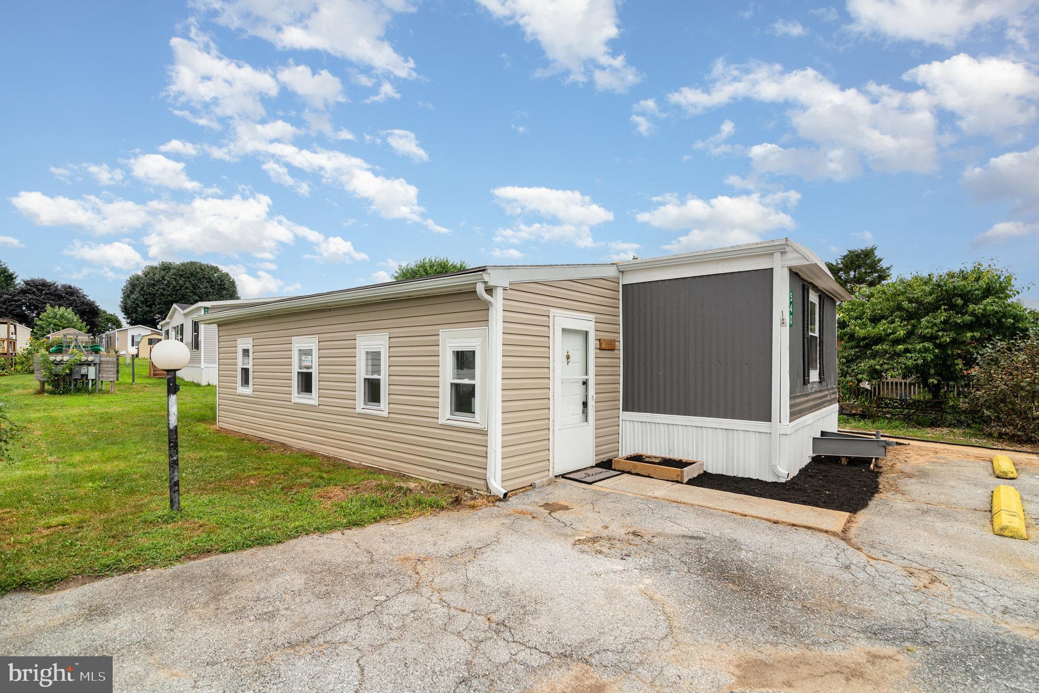 Welcome to this beautifully renovated and upgraded 3-bedroom, 1-bathroom mobile home offering just over 920 square feet of comfortable living space. This home features brand new windows throughout, allowing for excellent natural light and energy efficiency. The updated kitchen is equipped with solid wood cabinetry, granite countertops, a stove, and a dishwasher. Two bedrooms are located on the main level, while the third bedroom is situated in the finished addition, which also includes a convenient laundry hookup.
Enjoy outdoor living with a beautifully sized deck—perfect for peaceful relaxation or family entertainment. The property also includes a private driveway with parking for two vehicles.
Monthly lot rent is $430 and includes trash removal. Water and sewer are billed separately by the park, starting at a base rate of $55 per month for 2,000 gallons of water usage.
This affordable home is ideally located near local shops and restaurants, making it a great opportunity for comfortable and convenient living. Don’t miss your chance to make it yours!