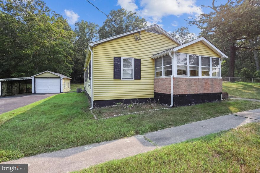 Great starter or downsizing opportunity. One level living surrounded by amenities and convenience. Two bedrooms and one bath home with front and back closed in porches all on 1 acre of land.  Enjoy the open land or live in current home while building your new home.  Enjoy the scenery and quiet of your own private yard.