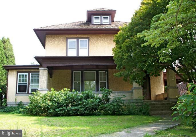 Spacious 2 Story Stucco home. Beautiful original woodwork. Lovely sun room, formal dining room, hardwood floor in the living room and dining room.