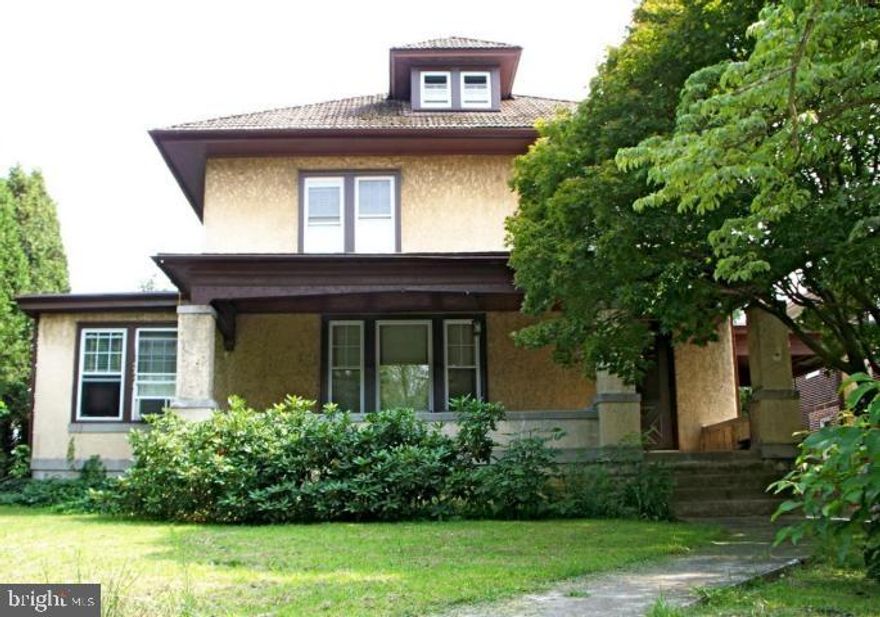 Spacious 2 Story Stucco home. Beautiful original woodwork. Lovely sun room, formal dining room, hardwood floor in the living room and dining room.