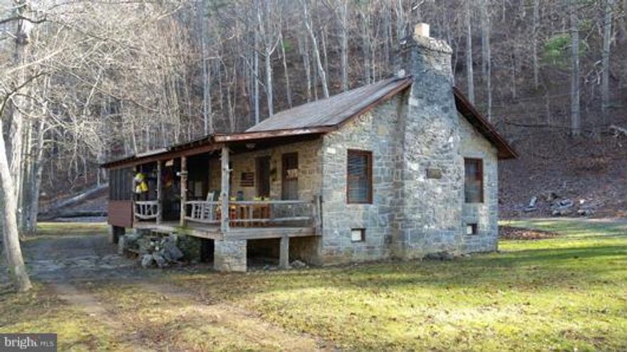 Cozy Stone Cottage along the Cacapon River, what could be more peaceful. Built in the 1930's  with solid stone walls, large fireplace, new roof, indoor full bath with running water. This cabin has always been used as a three season camp but could be modified for year round use. With 1.4 level acres and 350' of river frontage This little gem should be moved to the top of your list. Call today!