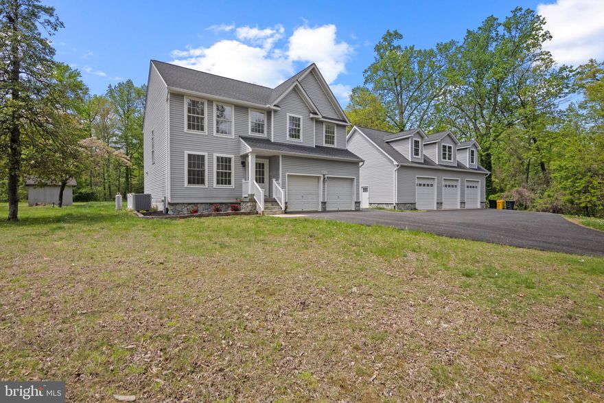 Stunning Updated Colonial in a Water-Privileged Community! This beautifully renovated four-bedroom, two-and-a-half bath home features a custom kitchen with all-new cabinetry, Calcutta Quartz countertops, and sleek stainless-steel appliances, including dual ovens with a gas cooktop. The inviting family room is equipped with built-in surround sound speakers, perfect for entertaining. The luxurious primary suite offers a spa-like experience with a large shower featuring dual shower heads, a soaking tub, a custom border-lit mirror, and a towel warming bar for those chilly days. Convenience is key with a second-floor laundry closet. Step outside from the family room onto a spacious Trex deck that overlooks a large backyard. The property includes an attached two-car garage and a fantastic 30x50 detached two-story toy barn garage, complete with a car lift 10' doors and 13' ceilings and the potential to finish the upstairs space into a perfect in-law or teen apartment. This home also boasts a new roof, a freshly paved driveway, and all-new plumbing and insulation. Enjoy the perks of a water-privileged community with access to a sandy beach and a community dock. This home and Detached garage sits on a double lot with separate gravel road on backside for easy access for boats, RV's storage. This home truly has it all!
