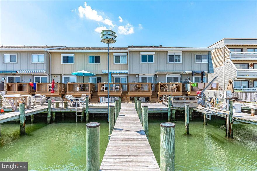 Direct Bay front  two bedroom one and a half bath condo has just been listed.  This beautiful condo is on 32nd St. and it is direct Bay front with a huge (42 feet) boat slip that will accommodate a very large boat or two boats or jet skis. The condo has an updated boat theme that's beautiful.  The kitchen has also been updated with white cabinets and has a clear view of the bay, and off the kitchen is a spacious deck that also overlooks the bay.  Also on the first level is a half bath. There is a stackable washer and dryer on this floor as well.  As you walk up the stairs you’ll immediately see the oars as railings, continuing the boat theme to the second floor.  On the second floor you will find two full bedrooms, one of which overlooks the bay.  There is also a full bath on this floor.  At night you will enjoy looking at all the lights from the Ocean City skyline and all the boats as they go by.  Whether you're into boating, jet skiing, kayaking, fishing or crabbing, this is a terrific home in an awesome location. You are close to the world famous Ocean City boardwalk, Jolly Roger amusement park, many restaurants and shops. There is also a community pool, making this is the perfect all around Ocean City home.  The condo is being sold fully furnished.   Come take a look today before it’s Sold!