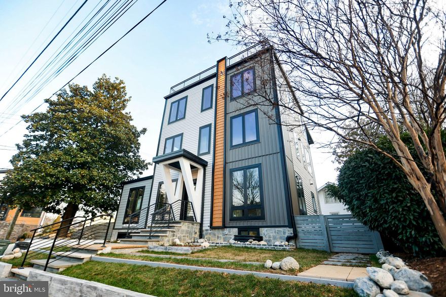 Welcome to this exceptional four-level contemporary residence, offering six bedrooms, five-and-a-half baths, and approximately 4,884 square feet of thoughtfully designed living space. Perfectly blending modern sophistication with everyday functionality, this home delivers an elevated lifestyle in a prime, metro-accessible location.

The open-concept main level features soaring 10-foot ceilings, rich hardwood flooring, and elegant craftsman-inspired finishes, creating a bright and seamless flow ideal for both everyday living and entertaining.

At the heart of the home is a true chef’s kitchen, equipped with premium Viking appliances, including a 48-inch built-in refrigerator and dual dishwashers. Quartz countertops, custom cabinetry, and an expansive center island provide both style and functionality—perfect for hosting or preparing gourmet meals.

Each of the six spacious bedrooms offers comfort and privacy, complete with custom walk-in closets. The luxurious primary suite serves as a private retreat, featuring a spa-inspired bath with a freestanding soaking tub, a curbless multi-jet shower, and high-end designer finishes.

Smart home technology is integrated throughout, allowing for effortless control of lighting, climate, and security systems—all accessible via smartphone or voice command.

The fully finished lower level is designed for entertainment and relaxation, featuring a media room, fitness area with en-suite shower, wet bar, and fireplace.

Step outside to a beautifully landscaped outdoor setting featuring a fully fenced patio—perfect for private gatherings, outdoor dining, and relaxation. The professionally designed landscaping enhances both curb appeal and everyday enjoyment, creating a serene and inviting environment.

A true highlight of the home is the spectacular rooftop deck, offering breathtaking views and an incredible space for entertaining or unwinding. This must-see outdoor retreat provides the perfect setting for sunset evenings, gatherings, or simply enjoying the surrounding scenery.

Additional highlights include energy-efficient systems, dual-zone HVAC, enhanced insulation, and Andersen Lifestyle windows that fill the home with natural light.

Ideally located just two blocks from the Virginia Square Metro, and just moments from top-rated restaurants, shopping, and vibrant urban amenities in Ballston, Clarendon, and beyond, with easy access to Amazon HQ2, the Pentagon, and Washington, D.C.—this home offers the ultimate combination of luxury, convenience, and lifestyle.