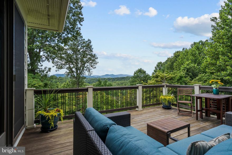 Nestled on a ridgeline with expansive mountain views, Tranquility Base is the perfect country get away.  The nearly 8 acre property, features a 3 bedroom craftsman style home, a 1 bedroom guest cottage, mature forests and over 300’ of river frontage on the Covington River.  You are sure to be enchanted by the year round mountain sunsets that are visible from any of the five decks, dining room, primary bedroom, guest bedroom, solarium and hot tub…nothing but nature between you and the incredible natural vista.  

Simply put, the home is perfectly sited on the property and thoughtfully designed to flow from the natural beauty of the landscape to the impeccably designed home.  A slate pathway gently curves from the circular drive through mature landscaping until you arrive at the front door which opens to another world of beauty.  

With 9’ ceilings, 3” oak floors and cherry/maple built in cabinetry throughout the main level, the home has a naturally warm feel.  The main floor features an open floor plan seamlessly flowing from the gourmet kitchen to the living room, complete with gas fireplace, to the fabulous dining room and is perfect for one level living.  A screened porch, perfect for enjoying your morning coffee or an evening cocktail, sits on one side of the dining room while the aptly named “sunset deck” stretches along the other side.  Separated by a long hallway from the main entertaining area, the primary suite envelopes the entire northern side of the home.  The main level is completed with an office which could be used as an additional bedroom, and the mud/laundry room that opens to the oversized 2-car garage.  Perhaps the best feature is that virtually the entire rear of the home is all windows to allow in the mountain views and the 12 months of amazing sunsets you are sure to enjoy.  

The upper level features a large bedroom replete with en-suite bath as well as a private sitting room.  The lower level features a family room with a wood stove, another bedroom, a home gym and a solarium (which makes another excellent office).  
The area around the home is nicely fenced off and features an amazing outdoor fireplace just calling out for a friendly gathering of friends and neighbors.  
A lovely one-bedroom cottage offers a retreat for the owners, extended family or visitors, just a short walk from the main house. Sunlight streams through the cottage's numerous windows, providing views of its own expertly landscaped garden. Two additional garage spaces under the cottage provide room for extra vehicles, tools or projects.  
A winding trail gently leads through the woods to the sun-dappled Covington River.  Make sure you take a moment to stop at the overlook about ½ way down and just enjoy the sounds of nature and the babble of the water.  
Despite its perfect privacy, the neighbors on the aptly named Grand View Road form a vibrant community and you are just minutes from the towns of “Little” Washington and Sperryville.  The Shenandoah National Park with its miles of trails, waterfalls and scenic vistas are only minutes away.  In addition to the SNP, Rappahannock features a bounty of art galleries, orchard & farms, wineries, breweries & a distillery as well as dining from casual to fine (everything is available from a simple burger, wood fired pizza to Michelin 3 star meal).