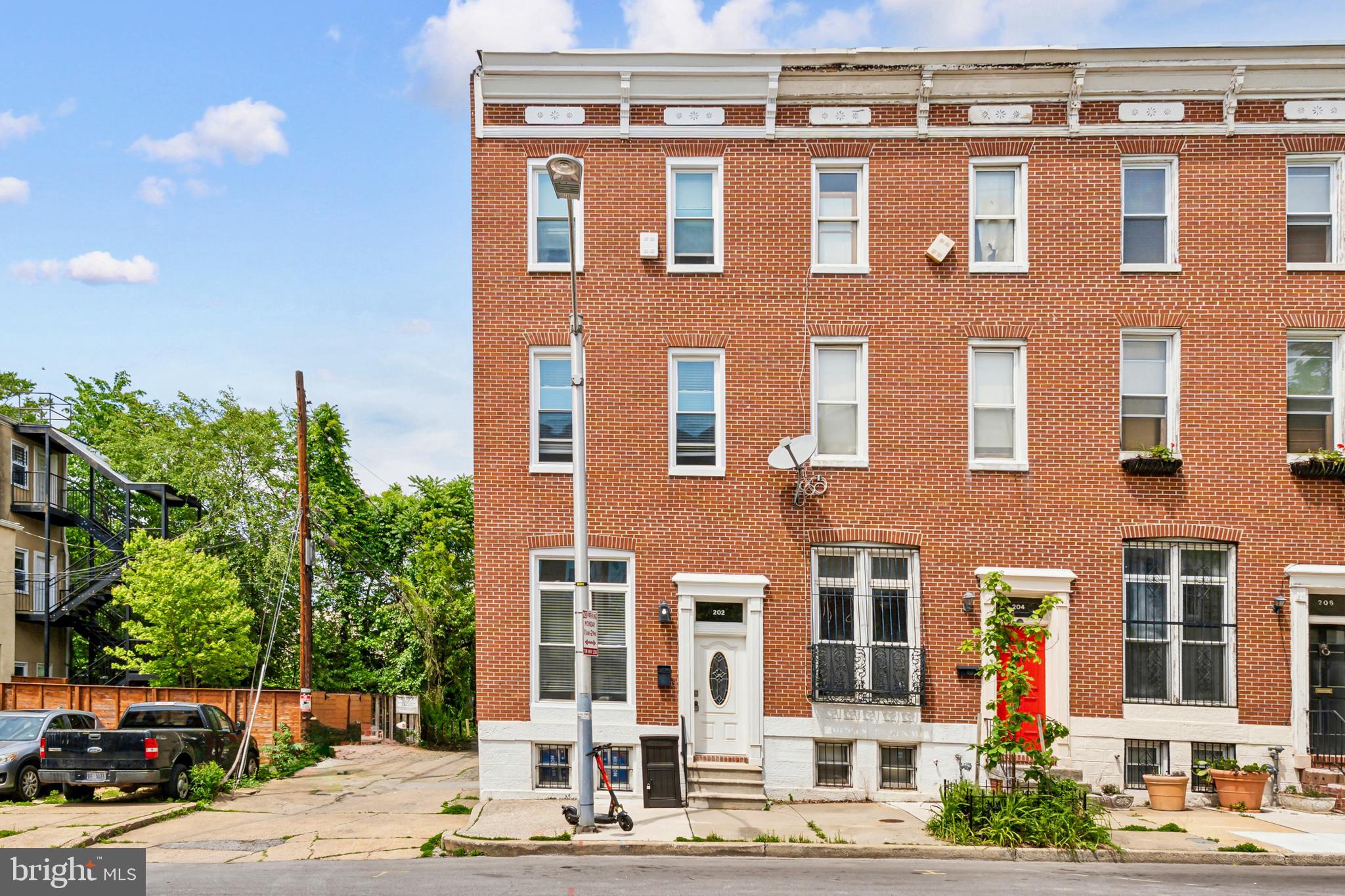 This renovated, end-unit townhome offers spacious rooms and tasteful finishes across three levels. The first floor features a comfortable living/dining room and a kitchen with shaker cabinetry, stainless steel appliances including a gas range, quartz countertops, and an island with seating for two. Each of the two upper levels has two bedrooms and a full bathroom (with an additional half bathroom on the second floor). Private outdoor space in the rear is an added bonus or can work as off-street parking for two cars.