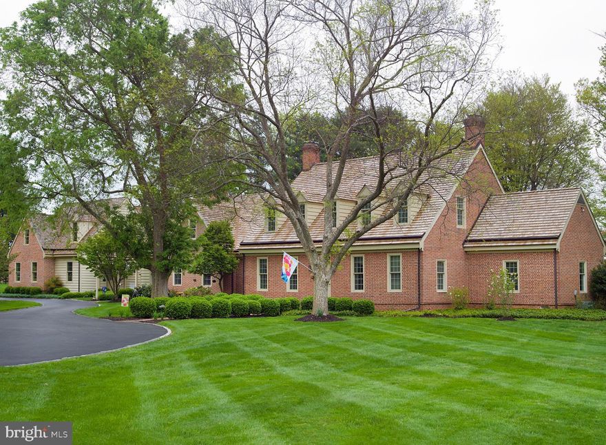 Rarely does a beautiful estate like this come on the market. This all brick, authentic, Williamsburg Colonial is located in the heart of the famed  Radnor Hunt  area of Chester County.  The original home was built in 1967. A major transformation started in 1991, superbly designed by acclaimed Chester County Architects McIntyre/Capron & Associates and expertly crafted by local Master Builder Steve Young. A true masterpiece with undeniable curb appeal was created at 419 Dutton Mill Rd. The house offers a flowing, functional floor plan wonderfully appointed with detailed crown moldings, chair-railings, wainscoting and recently renovated bathrooms and a convenient his and hers bath in the master. Additionally, there is a large 12 x12  cedar closet on the second floor. The large family room is very inviting with its open design and blends seamlessly with the updated, bright gourmet kitchen. There is a beautiful den which could be an option for a first-floor bedroom. The first-floor rooms use authentic glass panel doors to provide natural light and full views of the south facing rear yard with its abundant plantings, specimen trees, and a gorgeous well-manicured 4+ acres. Exquisite detailing of landscaping is complemented by expertly designed hardscaping, trellises and walkways. There is plenty of parking complemented by a wonderful 4 car garage, designed to flawlessly blend with the character of the original home. There are also opportunities for a horse barn, outdoor rooms, etc. In addition, the garage building also houses an "over the top", 1500 sq. ft. ,two story two bedroom carriage house, complete with indoor golf simulator (easily converted to a theater), unique wood flooring, gas fireplace, full kitchen, two bedrooms and a most convenient elevator. The carriage house would be ideal for in laws, children, or guests. The house is served by a whole house generator, well maintained mechanical systems, hydronic heating in the first floor of the garage and carriage house, four working fireplaces in the main house, sound system and a 1700 bottle wine cellar plus lots of more amazing amenities. Conveniently located in sought after Willistown Township, and close to all major routes and shopping.This beautiful home and its grounds is a rare place for peacefulness, privacy, and enjoyment of    life.