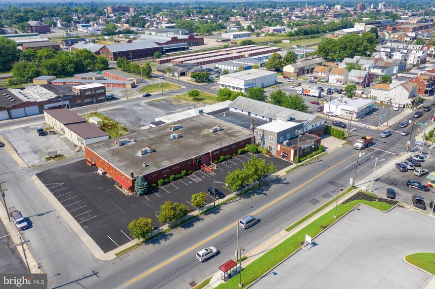 Excellent Owner User or possible Investment Opportunity with "Manufacturing Heavy" Zoning.  Approximately 37,636+/- SqFt above grade and 18,012+/- SqFt below grade of space totaling of 55,648+/-SqFt.  Property currently being used as Apparel Manufacturing facility (manufacturing and storage area, office space and retail store), Church (one larger service space and one smaller service space, office, and kids area), and large 2880+/- SqFt apartment with high end finishes, including beautiful kitchen, spacious rooms, 2 bedrooms, 2.5 baths, Master Suite with two walk in closets, gas fireplace currently used by owner of property.  The building is sprinklered.  33 lined parking spaces on paved parking area and large approximately 130' x 125' large stone parking area in rear of building that could accommodate truck parking or additional car parking.  Fenced and gated parking area in front of two large drive in garage doors.  2 loading docks.  Freight elevator.  Many possible uses for site and lots of opportunity.  Hoist at loading dock, mobile conveyor belt, and compressed air system are not included BUT are negotiable.