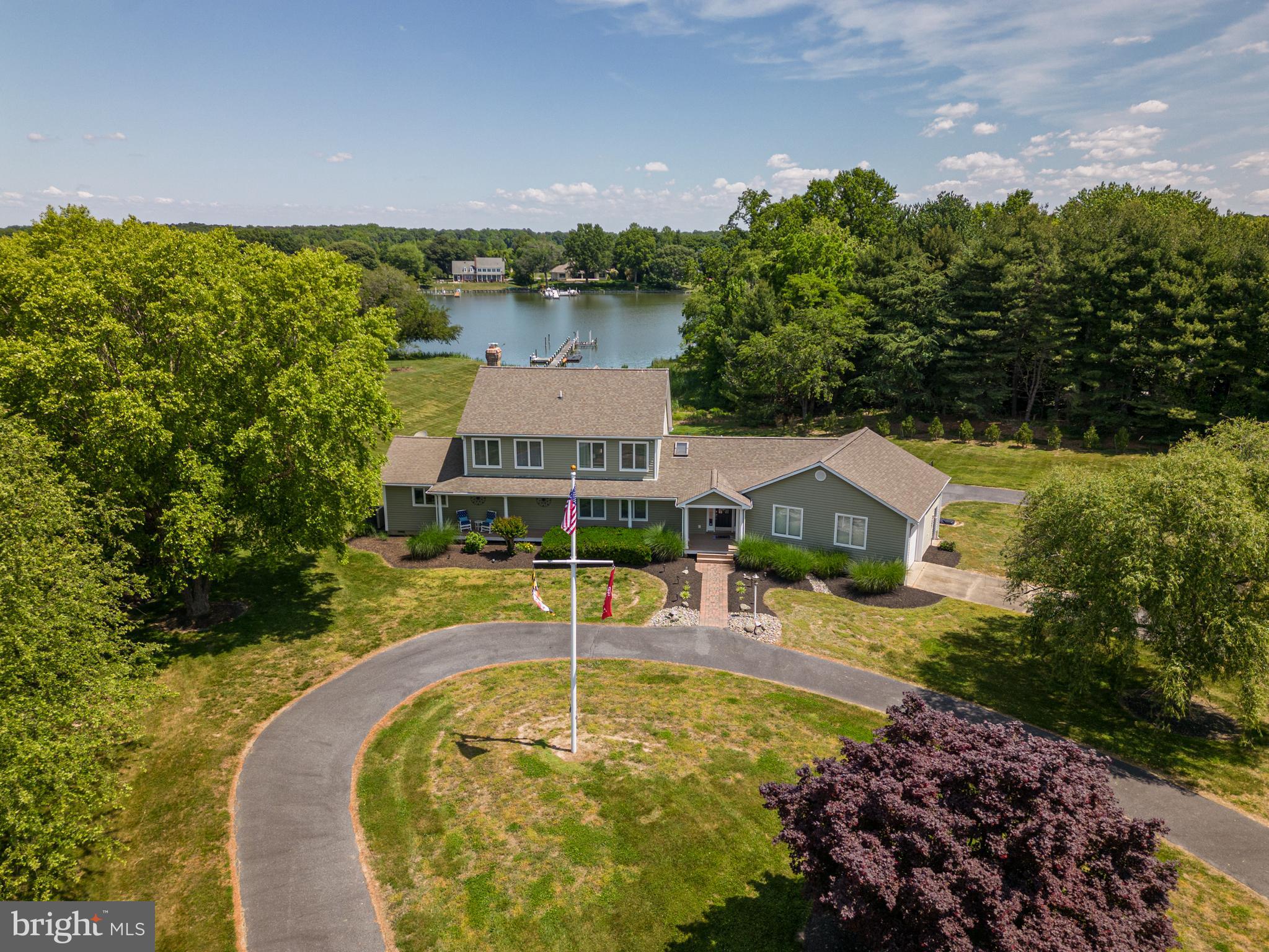 Overlooking Grove Creek, this gorgeous waterfront home is an absolute must-see! Spacious and filled with natural light, the open floor plan and vaulted ceilings give a sense of grandeur. The main level boasts a desirable primary suite with skylighted primary bath, beautiful stone fireplace, kitchen with huge island, access to multiple back decks and a relaxing sunroom with views of the creek and in-ground pool. Additional bedrooms upstairs, and large recreation room on the lower level with direct access to brick patio with hot tub that leads to the fully-fenced pool. Bonus room perfect as an office and built-in bar is perfect for entertaining. Outside you'll find a large shed, 3-car garage, and a private pier with multiple slips and boatlift.