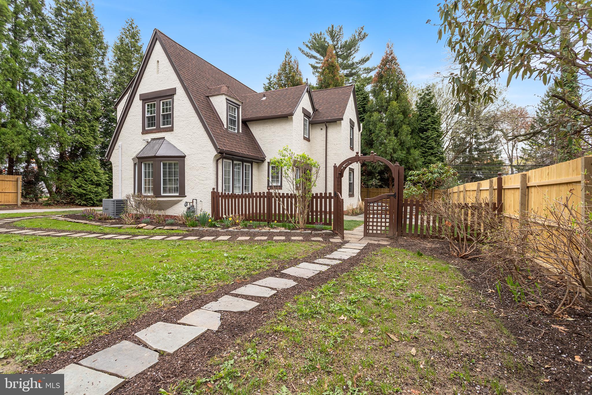 Welcome to this charming Tudor-style home located in the desirable community of Swarthmore. With its classic architecture and modern renovations, this 4-bedroom, 2.5-bathroom residence offers the perfect blend of old-world charm and contemporary convenience.
As you step inside, you’re greeted by a bonus space that can be used as a home office or mud room entry. Just past this room, the spacious living room features built-in bookcases, perfect for displaying your favorite books and collectibles. The formal dining room is ideal for hosting guests or enjoying family meals. The completely updated kitchen boasts modern finishes and ample storage, including a pantry to keep everything organized and easily accessible. Also on this level is a powder room and access to the outdoor patio. Please note.... the driveway is accessed from Cedar Lane however, the home can be accessed from the end of the cul-de-sac on Crest Lane.
Upstairs, you’ll find four well-sized bedrooms, each offering comfort and style. The bathrooms have been thoughtfully updated to reflect today’s design trends while maintaining the home’s classic aesthetic.
Outside, the property offers a serene and private retreat. The yard is enclosed with privacy fencing and surrounded by mature trees, creating a secluded and peaceful atmosphere. Whether you’re relaxing on the patio or enjoying outdoor activities, this yard is the perfect escape.
The unfinished basement provides potential for additional storage or future additional living space, with convenient laundry hookups already in place.
This home is the ideal mix of traditional elegance and modern functionality, offering a warm, welcoming space close to everything Swarthmore Borough has to offer as well as Springfield shops and I-476 for connection to all major roads. Don’t miss out on this beautiful property!