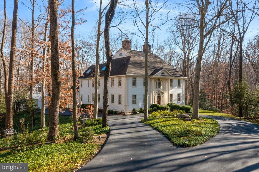Exquisite reproduction of 1750s Georgian Manor Home in sought-after Belvoir Farms situated on a 2.5 acre parcel surrounded by additional wooded community acreage ensuring abundant privacy. The property has a gated entry with monitored driveway and home security systems.  There is extensive custom millwork throughout with architectural touches and gleaming wide-plank pine floors.  The charm of times past coupled with the openness and high-tech features of modern living are all here. Formal living and dining rooms with fireplaces, beautifully appointed library and family room plus a gathering kitchen with stone fireplace on the main level provide gracious living and entertaining spaces.  On the second level, the primary suite features bedroom and adjoining sitting room with built-ins, ample closet space and a luxurious spa bath with access to an exercise room.  Two additional bedrooms, two full baths and laundry room complete this level.  The third level has a spacious living room/office with high ceilings and skylights, bedroom and full bath and two large walk-in closets – one cedar and one storage.  On the lower level, several recreation/game rooms plus full kitchen and bath allow the possibility for flexible living space.  Outdoor enhancements include an IPE deck with enchanting Snuggery (detached screened porch), a 2-car attached garage and 2-car detached garage.  
Community amenities include a marina, tennis court, pickle ball court, playground and numerous organized activities.   Conveniently located near commuting routes to Washington and Baltimore and BWI Airport.