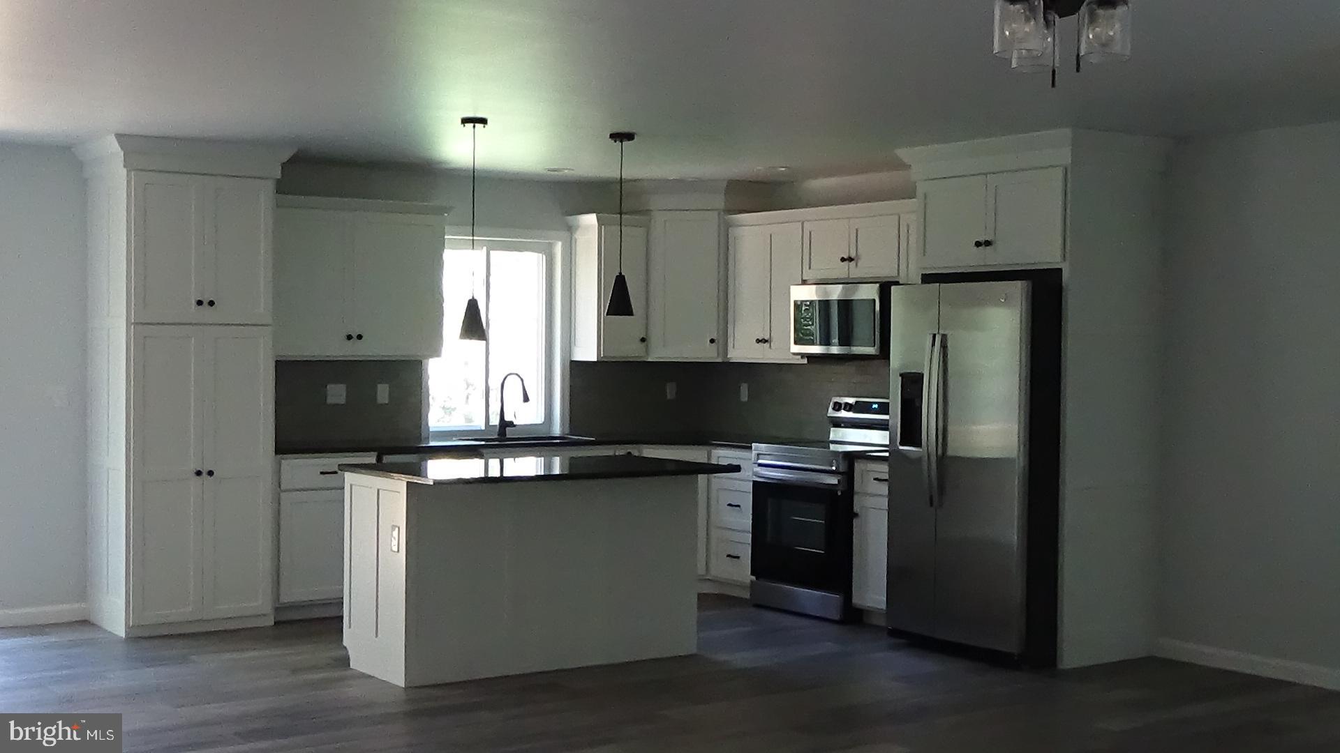 New Ranch home, all ready to move in. 3 bedrooms and 2 bath include a full master suite. Custom, local made, cabinets throughout with a full custom kitchen and all new appliances included. Kitchen also has a custom made island. Laundry has washer and dryer as well as large wash sink. The full walkout basement is wide open and could be finished. Clean water with a UV light and water softener. Along a quiet country road the property is mostly wooded and has wildlife. Take a look before it's too late.