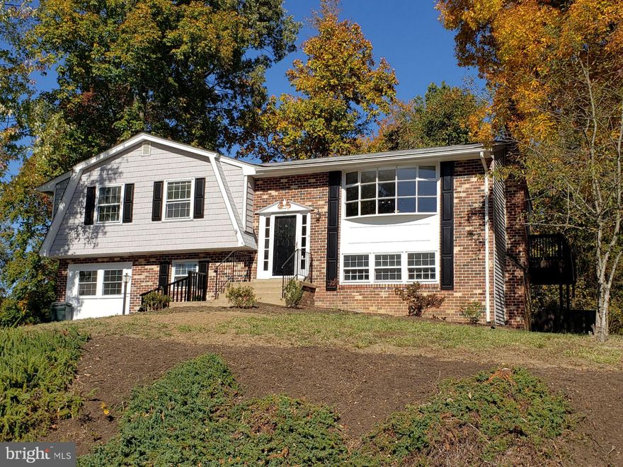 Welcome to your next home! In the beautiful Breezewood neighborhood at 6 Fairfield Circle you will find a rare gem.
This prize of a home is in a coveted prime location that is conveniently located just minutes from the I-95 exit and Courthouse Rd.  Houses move fast on Breezewood Drive in every economy and this opportunity to own a 5BR in Fredericksburg for under 400k is not something you can wait on.
As you walk into your new home, the flooring on the upper level is all new Luxury Vinyl Plank with an open and modernized kitchen; designed by a highly touted and nationally recognized Residential/Commercial Interior Designer of the year by La-Z-Boy®!
You will be mesmerized by the upgrades in the decadent quartz topped two-tone cabinets and island in your new expansive kitchen. Your next home has been redone from top to bottom.
You will love the new appliances as you walk through the open floor concept with the kitchen and family room leading to an epic bay window with an uncanny sunset view. 
The three spacious full Bedrooms and two full baths on the upper-level floor compliment the bay window’s simple but powerful impact.  Relaxing in your armoire, recliner or chaise lounge will be your regular escape as the abundant natural light and views soothe your senses like a normal house never could.
As you enter the lower floor, the enhanced living space will create a vision of the perfect warm Holidays you’ve always dreamed of with the whitewashed brick and traditional log fireplace. 
The updated bedroom to your left as you continue down the hallway will introduce you to a newly added and perfectly placed living space (the 3rd living room in your new home) with a new double window converted from a once garage.
Enjoy your new soft and long-lasting carpet on the lower level (and throughout your new home) which also features a full laundry room, a double French door leading under the deck and a new top of the line matching GE Washer & Dryer set.
The property has received massive labor and investment into the landscape to clear heavily overgrown shrubs and hazardous trees that adorn your new home with an impressive curb appeal as the corner lot stands out above the rest. The expanded driveway now has an additional spot for your parking needs which you will appreciate every time you park!