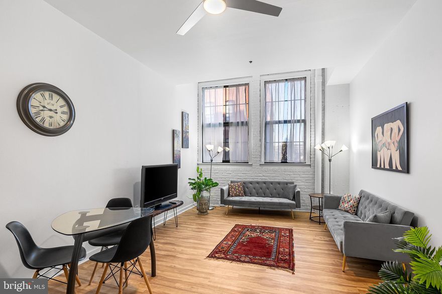 Welcome to Bridgeview Place Condominiums, a secure, pet-friendly, elevator building nestled on a charming, tree-lined cobblestone street in the heart of historic Old City. This stunning unit boasts soaring ceilings, expansive industrial windows, and a stylish new renovation, offering the perfect blend of modern design, convenience, and worry-free living. Note: this is a 1 bedroom with an extra flex room, accessed throuogh the bedroom, for dressing room, den, office, work out space, or whatever suits your needs. Upon entry a hallway welcomes you with a generously sized pantry/coat closet just to your right. The open-concept layout seamlessly connects the kitchen, bar seating, and living/dining area, creating an inviting space with excellent flow and functionality. The main living area is spacious enough for both lounging and dining, while exposed brick and oversized windows lean into the industrial-chic aesthetic. Head further into the unit and you'll find a newly renovated bathroom with the added convenience of in-unit laundry. The hallway and primary bedroom offer ample closet space and lead to the valuable flex room mentioned above.—an uncommon feature in Bridgeview Place units. Bridgeview Place offers exceptional amenities, including a 24-hour concierge, on-site management, and temporary guest parking in front of the building—perfect for unloading those groceries. Residents can also enjoy a shared courtyard with grills and a stunning rooftop deck featuring breathtaking skyline and river views. This location has a walk score of 96 and and ride score of 99, giving you unparalleled access to shopping, dining, public transport, and Philly’s magnificent history.