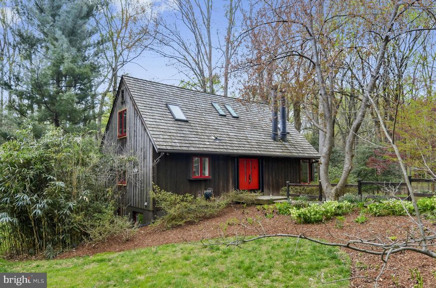 Charming Cottage in the Woods, steps from Great Falls Park trails.  Custom house is for the creative, artistic, and interesting.  Set on two lots; feasibility study available for 2nd septic system. 9117 is 2nd lot.  Open floor plan kitchen/dining room leads to deck overlooking the property; sunroom on main level; recreation room, master or guest suite on walk-out lower level.