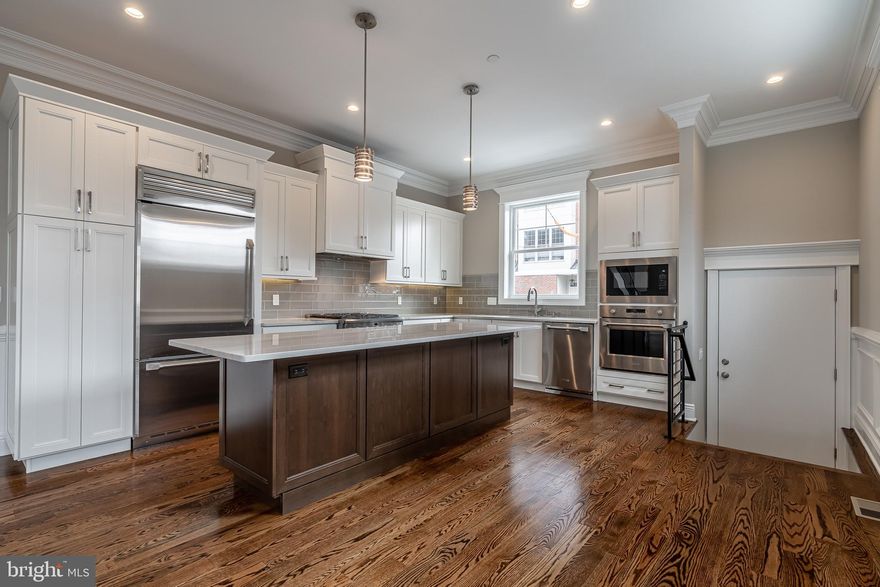 NEW  CONSTRUCTION WITH TWO - CAR PARKING located in the heart of Graduate Hospital neighborhood. The home is situated on a corner lot. An abundance of windows allows sunlight in every room. As you enter the first-floor notice the 10' high ceilings, open layout, and trim package that includes wains coat, oversized millwork, and crown molding. Large living room with gas fireplace and granite surround. Dining area and Gourmet kitchen featuring Century Cabinetry, an 8' island, granite countertops, and G.E. Monogram stainless appliances.  The second floor has two spacious bedrooms, two full baths, and a laundry room. On the third floor, you will find your master suite with extra den/office, oversized walk-in closet with custom shelving throughout and a beautiful bathroom with double vanity, large walk-in shower, and separate soaking tub. In the lower level, you will find your second living area, full bath, and potential fourth bedroom area in the back. Other features include 10-ft ceilings throughout, custom built-ins in every closet, two separate Carrier HVAC systems, Central Vac system, tankless water heater, Security/Camera Monitoring, Ring Doorbell, and Honeywell Home Thermostats. A roof deck with beautiful skyline views and a two-car driveway complete this must-have home. 1 Yr Builders Warranty Included and Pending 10-Yr Tax Abatement.