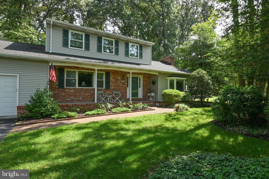The quintessential two-story home on a private wooded lot at the end of a no-through street. Quality and class throughout with wide plank hardwood floors,  kitchen updated with granite countertops, tiled backsplash and stainless appliances and recently renovated bathrooms. The large step down family room just off the kitchen has a brick hearth fireplace with wood burning insert. Gather together in the sunroom with adjacent, professionally designed composite deck with built-in benches overlooking the .84 acre lot with irrigation system. Enjoy quiet evenings on the porch with stunning mature trees in the front yard. Bring your boat, kayak, paddle board and fishing rods! Sylvan View on the Magothy has a community marina, boat ramp, and absolutely breathtaking beach with playground and volleyball. A lifetime of memories await!