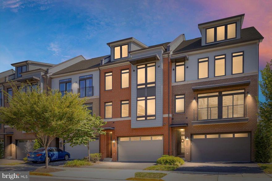 Welcome to this pristine, light-filled luxury townhome offering more than 3,850 square feet of beautifully designed living space in the highly desirable Village at Leesburg. This elegant NV Homes Tyson model is one of only seven in the community that backs to open green space, providing both privacy and tranquil views, including a picturesque pond from the main living areas. Spread across four spacious levels, the home features 4 bedrooms, 4.5 bathrooms, and multiple outdoor living spaces, including a private terrace off the fourth-floor loft. The main level shines with a stunning center gourmet kitchen equipped with GE Profile stainless steel appliances, granite countertops, abundant storage, wide plank hardwood flooring, and a large balcony ideal for entertaining. Upstairs, the primary suite boasts two walk in closets and a spa inspired bath, while two additional generously sized bedrooms share a hall bath with double vanity. The top level loft offers a private retreat complete with a bedroom, living area, full bath, and terrace. The lower level adds even more living space with a light filled recreation room, large windows overlooking the backyard, and another full bath. Additional highlights include a two car garage with a 50 amp outlet, a spacious driveway, plentiful guest parking, and modern conveniences such as dual zone HVAC, Nest thermostats, Cat 6 wiring, and a wireless security system. All of this is just steps to Wegmans, Coffee shops, shopping, dining, and entertainment! With easy access to Ida Lee Park, W&OD trail, the Symington Aquatic Center, One Loudoun, Dulles international airport, Ashburn Metro Station and major commuter routes including Route 7, Route 15, and VA 267. This is luxury living at its finest in one of Leesburg’s most vibrant communities!