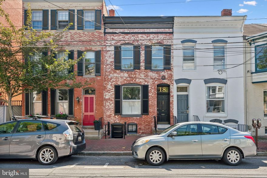 OFFER DEADLINE SUNDAY 9/8 AT 5 PM. Discover a piece of Frederick's history with this charming 3-bedroom, 1.5-bathroom rowhome, beautifully updated and nestled in the heart of Historic Downtown Frederick. Built in 1890, this all-brick row house offers a blend of classic character and modern convenience. Enjoy the convenience of nearby dining, unique shopping, and the scenic Carroll Creek with its walking paths and vibrant community events.

Step inside to find gleaming hardwood floors throughout, complemented by two fireplaces in the living and dining rooms. The spacious kitchen boasts custom soapstone countertops with a stylish backsplash, ample room for dining, and a second stairway leading to the upper floor. On the second level, you'll find three generously sized bedrooms, each with hardwood flooring, and a full bath featuring a vintage clawfoot tub. One bedroom even includes a private balcony overlooking the beautifully landscaped, partially fenced backyard.

Additional features include a dual zone HVAC system, an 80-gallon hot water heater, updated electric and new recessed lights in basement, new ceiling fans, neutral paint, metal roof, and lovely kitchen and bathroom spaces (both toilets replaced recently). The lower level offers an unfinished basement with plenty of storage space and a poured concrete floor. Outside, enjoy the brick patio and spacious backyard, perfect for relaxing and entertaining.

This home combines historic charm with modern updates in a prime location. Don't miss your chance to own this unique property—call today to schedule a viewing!

Do you need garage parking? A garage just opened up right by this home and is being held available over the weekend for the potential new owner at a rate of $150/month. Listing agent will provide details to buyer agents.