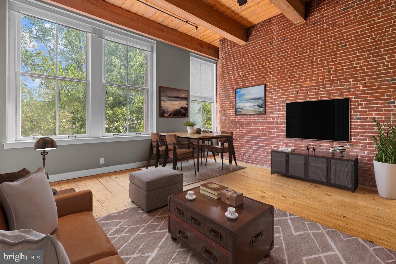 Welcome to this beautifully maintained 1-bedroom, 1-bath condo with a versatile bonus room, perfectly situated in the heart of historic Old City Philadelphia. This unit faces south onto a tree lined Arch Street overlooking the historic Quaker Meeting House. Just minutes from Center City, this home offers the ideal blend of urban convenience and neighborhood charm; it boasts all the character of the early industrial age: exposed brick and beams, wide plank natural wood floors, enormous factory windows that channel an immense amount of natural light into the living area. A galley kitchen outfitted with a tile backsplash, stainless steel appliances, wood cabinetry, and granite counters peer on to the open plan living area. A bedroom with a closet and laundry is tucked behind the kitchen area on the main level. A spiral staircase leads to the modern bathroom and loft area which can be used as an extra sleeping area, an office, in-home gym; all capped with towering ceiling height that adds space and depth to the loft experience. Some history of the building: The Hoopskirt Factory was built in the 1800's to manufacture bouffant petticoats that were a mainstay of women's fashion at that time. The units still maintain much of character. Whether you’re a first-time buyer, downsizing, or seeking an investment in a prime location, this Old City gem is a rare find. Schedule your private showing today!