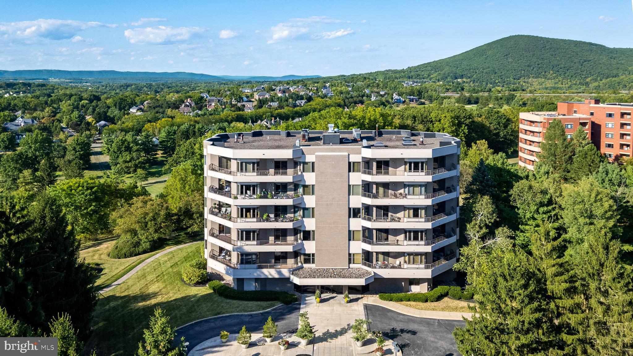 Exceptional condominium opportunity at The Summit offers a distinctive State College experience. Wrap yourself in luxury with exquisite style and care-free living, all near shopping and bike/walking paths. Enjoy the peace of mind of a secure entry system and elevator service opening directly into your private residence. Take in sweeping mountain vistas and fresh breezes from expansive windows and terraces, or relax in the sunroom while enjoying stadium views. Impressive selections and finishes are displayed throughout this residence, including marble, hardwood, tray ceilings, French and pocket doors, and handsome moldings. The spacious custom kitchen is outfitted with a Sub-Zero refrigerator, Wolf cooktop, built-in wine/beverage fridge, granite countertops, and a breakfast nook. Special occasions are celebrated in the formal dining room, while the office/library with custom built-ins and the family room provide favorite spots to unwind. The primary en suite is a private retreat with access to a secluded patio. An additional bedroom, full bath, laundry/utility room, half bath, gallery foyer, and elevator entry area complete this impressive dwelling. Summit amenities include a guest suite, luxurious guest apartment with kitchen, fitness room, two below-grade parking spaces, heated in-ground 20'x40' swimming pool, storage area, and an on-site building manager.