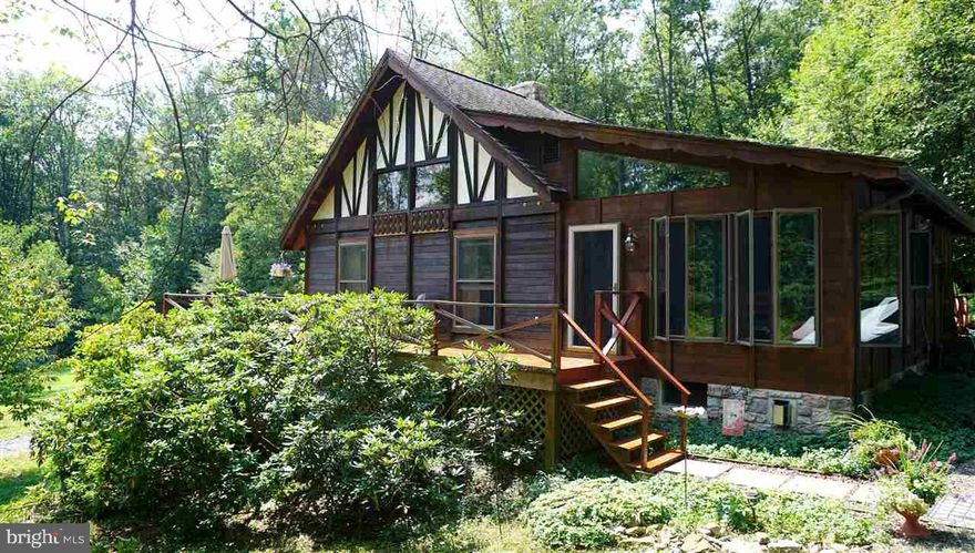 Totally secluded 3-4 bdrm, 1.5 bath Swiss Chalet w/modern addition on 75 ACRES bordering State Forest land!  Features central air, vaulted ceiling, exposed beams, stone chimney and redwood paneling throughout.  Also, modern kitchen w/U shaped Quartz counter-top, gas range, dbl oven, stainless steel features & tile floors.  Downstairs - cozy den w/gas FP.  Wrap around deck & screened porch.  Timber included!