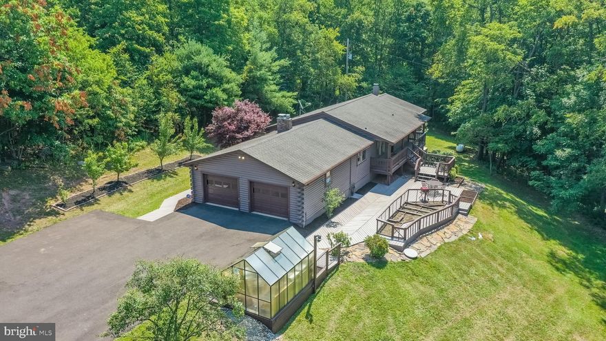 Properties like this don't come around very often... 80 acres surrounded by state forest and a home that has been meticulously updated and cared for. Enjoy immense privacy and freedom on the large parcel, mostly wooded, with fruit trees around the house. Once home to an avid gardener, the green house and vegetable gardens are ready to be made into your sanctuary. Days and nights were meant to be spent relaxing on the extensive decking, looking out over the gently sloping lawn. Once you step inside this log home, you'll be blown away by the amount of space that is waiting for you. Deceivingly modest from the exterior, be ready to enjoy over 3000 sq ft of finished space. New flooring throughout the main level and a remodeled living room will blow you away! The spacious eat-in kitchen attaches to a separate dining room and has abundant storage.3 bedrooms and 2 baths on the main level give plenty of space. Downstairs, the HUGE living space features brand-new carpet. Be sure to remove your shoes to get the full experience, it feels wonderful to walk on! Imagine the possibilities with this large space, living and rec room, exercise and office, hobbies, anything you can imagine can happen here! You'll also enjoy another sleeping space or office, plus an adorable full bath with black and white checkered flooring that emulate style! The large utility room also just got a face lift with updated paint! This space is fantastic for storage and still has room for a workshop. From here, walkout to the beautiful front yard. The convenience of the attached 2 car garage will keep you happy all year long.  And don't forget about the additional outbuilding! What would you do with a gorgeous home on 80+ private acres?? Find out today, call for your appt before it's gone!