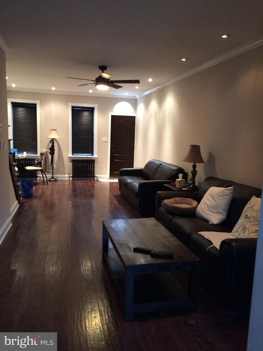 This beautiful townhome is bright and airy.  Enter into a hardwood floor throughout open floor plan living and dining room, the modern kitchen is separated by an oversized archway offers plenty of counter space.  The patio/garden area with built in barbeque station.  Upstairs is a wide open one bedroom with walk-in closet.  The classic oversized bathroom has a claw foot tub and plenty of space for storage or a vanity table.  The basement houses the washer, dryer and storage.  Located within steps of Broad Street, easy public transportation routes to center city.  Plenty of restaurants and cafe nearby.