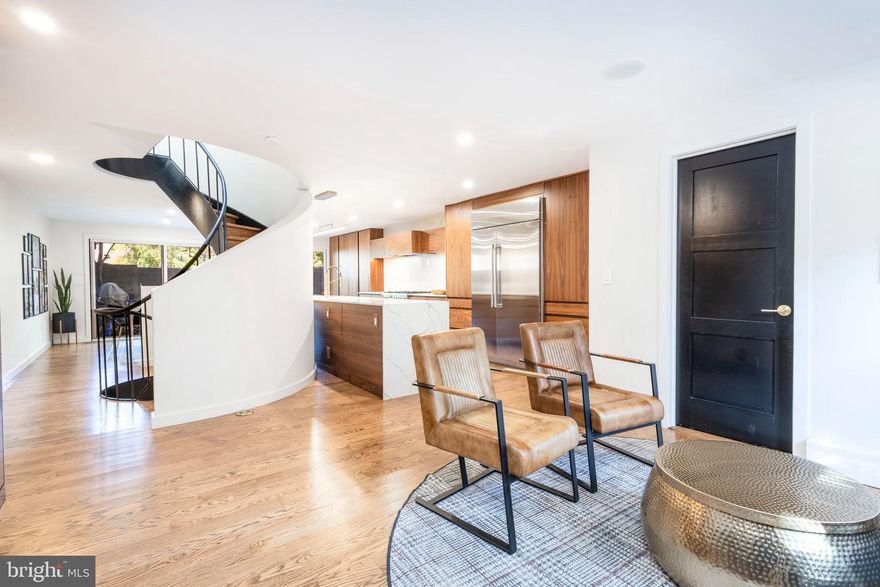 Welcome to this pristine residence, one of just 37 contemporary townhomes designed by internationally acclaimed architect I.M. Pei, nestled on a quiet street in the heart of historic Society Hill. This is a rare opportunity to own a piece of architectural history that blends timeless mid-century modern design with sophisticated, urban living.

This smart home was completely and elegantly renovated in recent years, with premium upgrades throughout, including all-new bathrooms and kitchen, wood flooring throughout ,a finished basement, custom built-ins, and so much more, offering turnkey luxury with enduring style.

Step inside to a bright, open floor plan filled with natural light. Rich, authentic hardwood floors run throughout, complementing the home’s clean, modern aesthetic. The chef’s kitchen is a true showstopper, equipped with high-end appliances, a large waterfall island, and custom wood cabinetry providing ample storage and generous counter space. It flows seamlessly into a spacious dining area that opens to a private backyard through wall-to-wall sliding glass doors, perfect for indoor-outdoor living and entertaining. Also on this main level is a beautifully finished full bathroom, adding convenience and flexibility for guests or first-floor living.

Just beyond the garden lies your personal parking space, located in a central, beautifully landscaped courtyard behind the homes. At its center is the striking second casting of Gaston Lachaise’s sensuous sculpture, “Floating Figure”, a unique and elegant focal point that anchors the community. Additional guest parking space available in this area.

One of the home's most remarkable features is the original curved central staircase, a sculptural masterpiece in itself, spanning all four floors and illuminated by a large overhead skylight. Truly a work of art.

The second floor boasts  a formal living room with large windows, a wood-burning fireplace, custom built-ins, and sliding glass doors opening to a charming wrought-iron balcony. Also on this level are two spacious bedrooms with ample closet space and a beautifully appointed full bath. The third floor is a sun-drenched retreat, featuring a gracious primary suite with stunning views of the Ben Franklin Bridge, a custom-designed spa bath, and extensive closet space. Another large bedroom with wall-to-wall windows, and a dedicated laundry room complete this level.

The finished basement offers flexible living options, ideal for a home gym, media room, office, or guest space, along with a mechanical/storage room that adds practical functionality.

Situated in the highly regarded McCall Elementary catchment zone, this residence is just steps from the city’s best offerings, including the award-winning Zahav restaurant, named the #1 restaurant in America. You’re also moments from Philadelphia’s premier dining, cultural institutions, parks, and hospitals such as Jefferson, Pennsylvania, and Cooper.

This home is more than a residence, it’s an architectural treasure in one of Philadelphia’s most desirable neighborhoods.