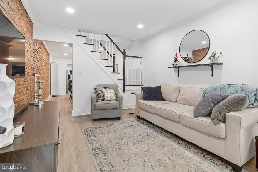 This Home Qualifies for Zero Money Down! Charming updated Locust Point home situated on a quiet street with rear parking pad and brand new roof is move-in ready!  This cozy home is full of  character with classic brick walls and modern updates that include new luxury plank flooring throughout, all new windows, fresh paint, recessed lighting, and light fixtures. The living room is warm and welcoming with sunlight streaming in the large front window, grand center staircase, family sized dining room that leads into the modern gourmet kitchen with stainless steel appliances, gas burner stove, granite countertops, gleaming backsplash, a powder room and door out to your private parking pad.  Stacked laundry is tucked away at the entrance of the kitchen. Upstairs are two spacious bedrooms.  The primary bedroom has large windows, brick accent wall and ceiling fan. The second bedroom is also full of character with a large closet, wood ceiling and ensuite bathroom with shower and linen closet. The lower level is a great space for storage. Walking distance to Latrobe Park, UA Headquarters, Fort McHenry, the water taxi, coffee shops, restaurants and stores. Easy access to 95 and 895!  Schedule your tour today!