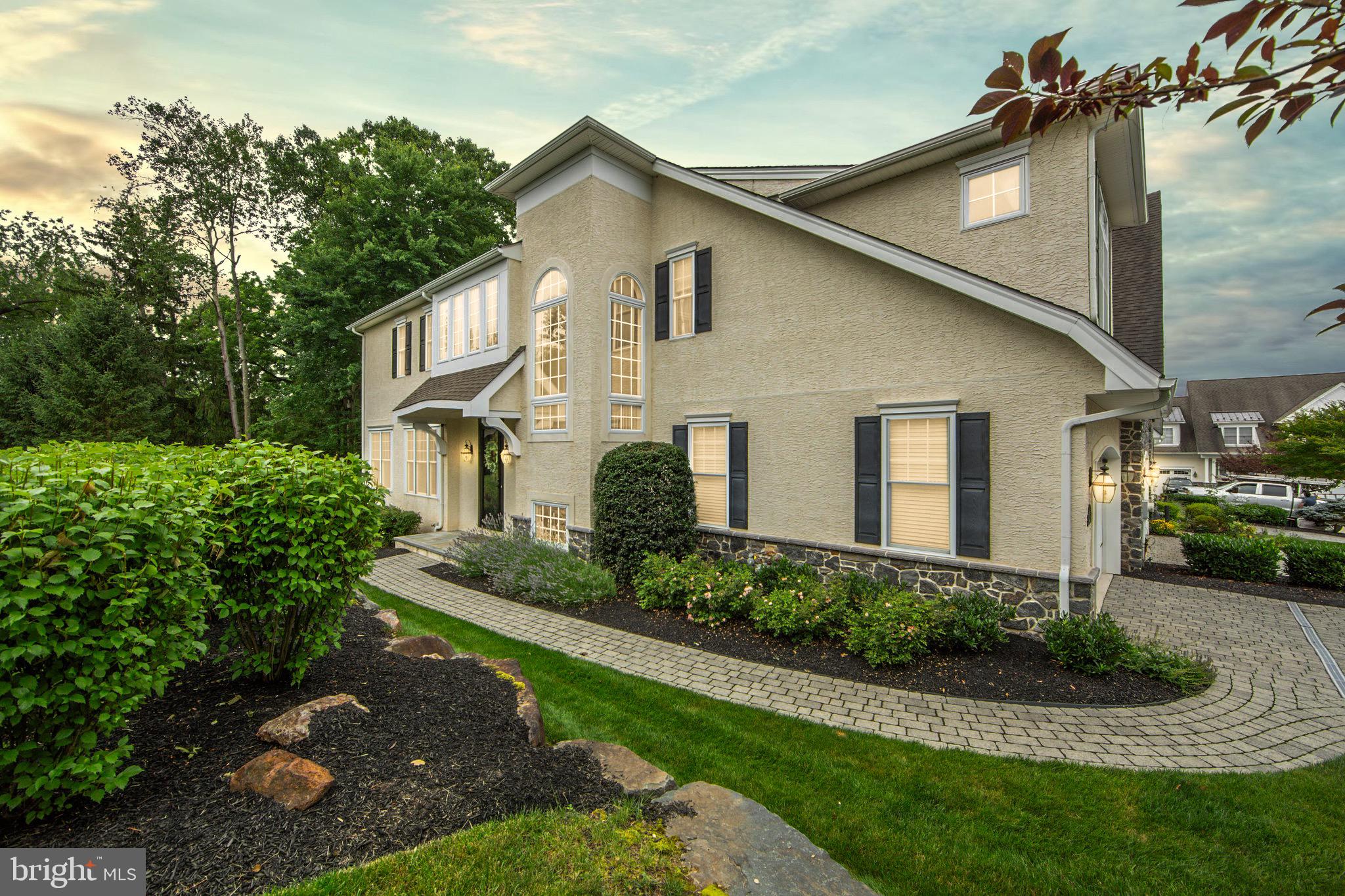 EXQUISITE 3 Bedroom,2.5 Bath end unit carriage home in desirable Brinton Village . Perfectly positioned on one of the community’s most desirable lots, this home stuns from the curb with meticulous landscaping and a custom hand-laid stone walkway. Inside, an elegant two-story foyer welcomes you with gleaming hardwood floors and an open, light-filled layout. The heart of the home is the beautifully upgraded kitchen featuring granite countertops, a custom subway tile backsplash, and a sunlit eat-in area. The kitchen flows seamlessly into the family room, where a striking fireplace adds warmth and charm. Oversized sliders lead to a private deck overlooking lush, professionally maintained greenery—your own outdoor oasis with none of the upkeep. A formal living room and dining room complete the main level, enhanced by natural light, neutral finishes, and elegant architectural details like upgraded moldings and decorative column. Upstairs, a spacious loft with custom plantation shutters offers flexible living space-perfect as a home office, reading nook, or media area. Two generously sized bedrooms share a full bath, while the primary suite is a true retreat with vaulted ceilings, dual walk-in closets, a dressing area, and a luxurious en-suite bath with double vanities, a soaking tub, and an oversized glass shower. The finished lower level offers even more space, ideal for a rec room, home gym, or additional family living area—ready to be tailored to your lifestyle. Enjoy a carefree lifestyle. This lovingly maintained and extensively upgraded home offers both sophistication and comfort, inside and out. Don’t wait—schedule your tour today and make this dream home your reality.