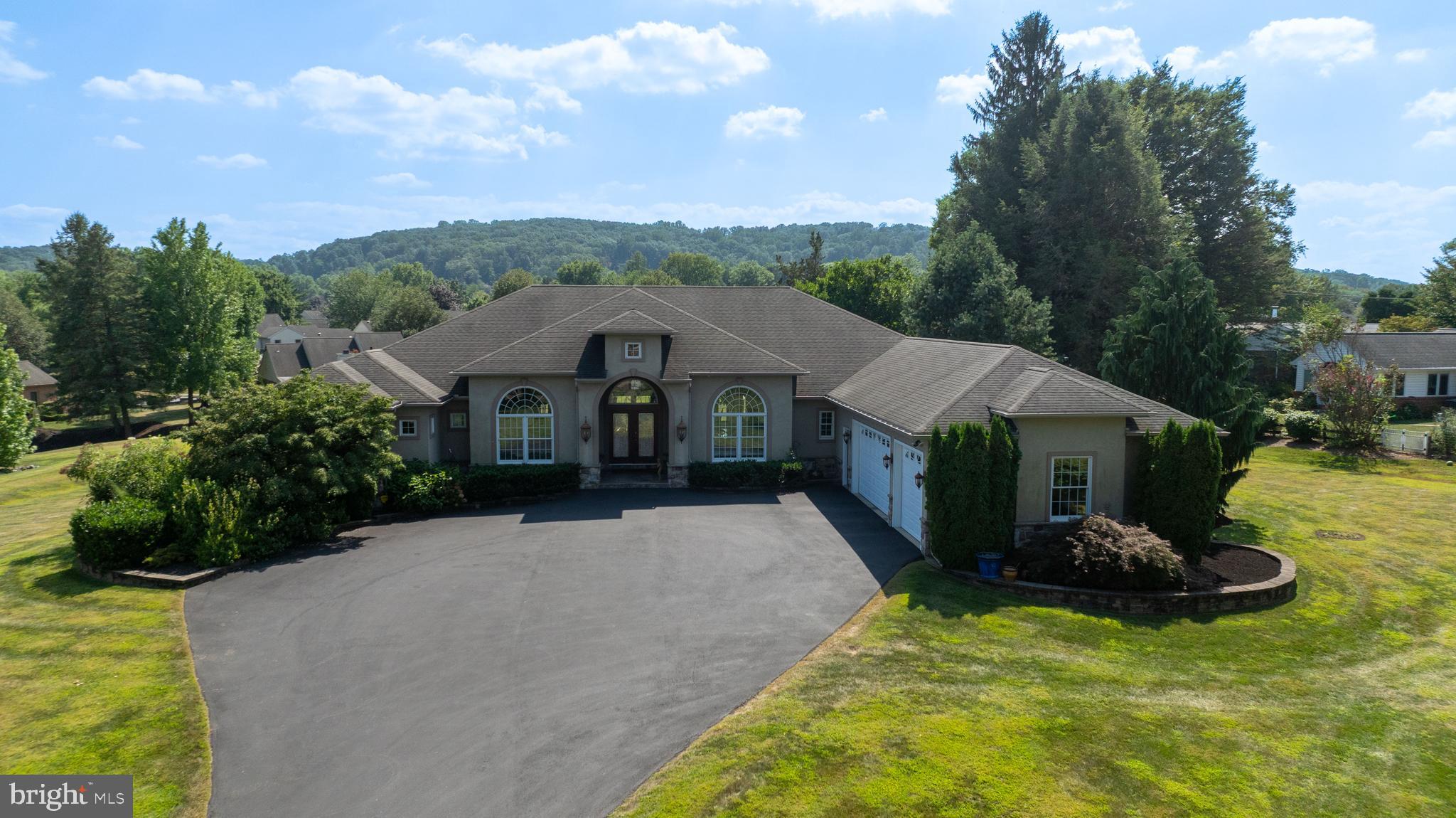 Welcome to 890 Fishburn Road!
Nestled on a sprawling 1.7-acre lot in desirable downtown Hershey, this custom-built Mediterranean-style home offers a rare blend of privacy and convenience. Located just moments from local schools and attractions, the property provides a serene retreat without sacrificing access to everything the area has to offer.
Step inside this 4,003-square-foot main level and be greeted by an open, flowing floor plan with soaring ceilings and custom lighting that enhances the home's casual elegance. The custom kitchen is a chef's delight, featuring granite countertops and high-end finishes. Tray ceilings and skylights in both full bathrooms add an extra touch of sophistication and natural light.
The residence includes four bedrooms and two and a half bathrooms on the main level. The master bedroom is a true sanctuary, thoughtfully designed as its own private wing. It features a custom closet, a luxurious en suite with a whirlpool tub, and a two-person shower. On the opposite side of the home, three additional uniform bedrooms ensure comfort and privacy.
Three gas fireplaces, two of which are adorned with beautiful marble, create a warm and inviting atmosphere. Custom decorative inserts can be found throughout the home, adding a unique and personalized touch. Enjoy the outdoors from the extra-large rear porch, which features stunning stamped concrete, perfect for relaxing or entertaining.
The lower level of this home is anything but typical. With higher ceilings and poured concrete walls, this space was crafted for both comfort and entertainment. It features a stunning, extra-large imported Italian marble gas fireplace—a rare centerpiece—and an extensive bar area.
Movie nights are elevated in the dedicated theater room, complete with a stage and surround sound. For ultimate relaxation, indulge in the custom steam sauna, which includes a shower. The lower level also boasts a half bathroom, custom Mexican doors, custom painting, and durable cork flooring, making it a truly unique and functional space. Additional features like a central vacuum system and engineered floor joists speak to the quality and thoughtful construction of this exceptional home.