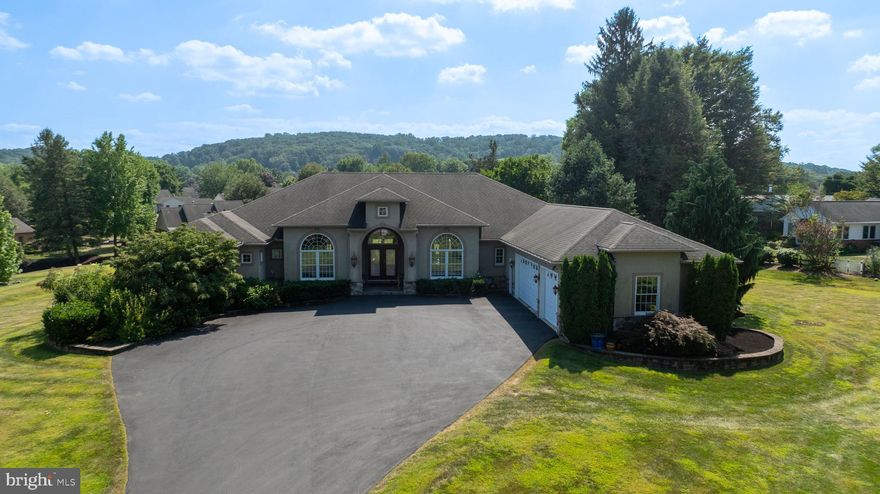 Welcome to 890 Fishburn Road!

Nestled on a sprawling 1.7-acre lot in desirable downtown Hershey, this custom-built Mediterranean-style home offers a rare blend of privacy and convenience. Located just moments from local schools and attractions, the property provides a serene retreat without sacrificing access to everything the area has to offer.

Step inside this 4,003-square-foot main level and be greeted by an open, flowing floor plan with soaring ceilings and custom lighting that enhances the home's casual elegance. The custom kitchen is a chef's delight, featuring granite countertops and high-end finishes. Tray ceilings and skylights in both full bathrooms add an extra touch of sophistication and natural light.

The residence includes four bedrooms and two and a half bathrooms on the main level. The master bedroom is a true sanctuary, thoughtfully designed as its own private wing. It features a custom closet, a luxurious en suite with a whirlpool tub, and a two-person shower. On the opposite side of the home, three additional uniform bedrooms ensure comfort and privacy.

Three gas fireplaces, two of which are adorned with beautiful marble, create a warm and inviting atmosphere. Custom decorative inserts can be found throughout the home, adding a unique and personalized touch. Enjoy the outdoors from the extra-large rear porch, which features stunning stamped concrete, perfect for relaxing or entertaining.

The lower level of this home is anything but typical. With higher ceilings and poured concrete walls, this space was crafted for both comfort and entertainment. It features a stunning, extra-large imported Italian marble gas fireplace—a rare centerpiece—and an extensive bar area.

Movie nights are elevated in the dedicated theater room, complete with a stage and surround sound. For ultimate relaxation, indulge in the custom steam sauna, which includes a shower. The lower level also boasts a half bathroom, custom Mexican doors, custom painting, and durable cork flooring, making it a truly unique and functional space. Additional features like a central vacuum system and engineered floor joists speak to the quality and thoughtful construction of this exceptional home.