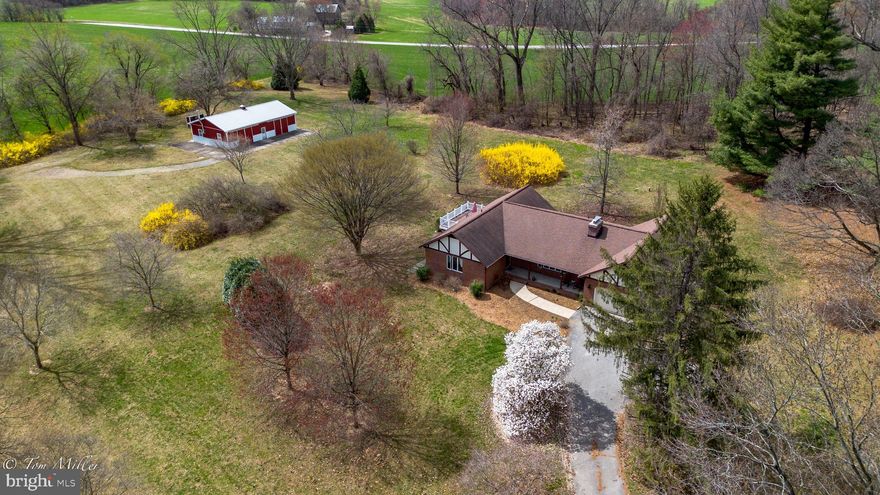 Welcome home to the privacy of your own park like setting in the heart of the Hereford Zone! This large brick rancher is nestled on just over 4 flat acres, surrounded by trees and beautiful gardens. Delight in the views from your back deck or front porch. Enjoy the serenity of country living and the convenience of close proximity to Hereford shopping & dining as well as Hunt Valley, Shrewsbury & Hampstead. Inside, cozy up to the lovely brick fireplace. Cook up delicious meals in the large Country kitchen. Entertaining is a breeze in this well thought out floor plan, whether you're hosting an intimate gathering or a large party! The property also includes a large 30 X 50 foot outbuilding with  electric & water. So many possibilities including a barn, party room, workshop, car or equipment storage, or put in a pool and make it a pool house! Don't miss this rare opportunity that checks all the boxes!!
