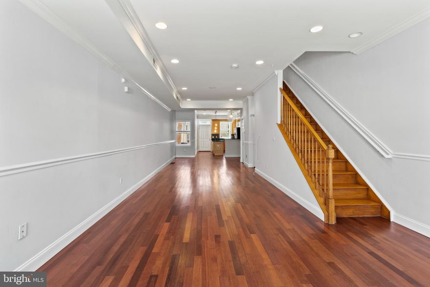 Prepare to be impressed by the wide layout of this home with finished basement and large patio in NewBold. This 1,634 SF home sits on a 16' x 69' lot, has an open floor plan, 3 bedrooms and 1.5 baths. And the best part is, all 3 bedrooms are large. The house offers high ceilings, HW floors throughout the first and second floor, gorgeous crown molding, over-sized kitchen that includes a separate built-in desk , SS appliances, 42" cabinets, granite counters & island and a glass tile backsplash. The rear door leads to a deep concrete patio with plenty of space for outdoor entertaining. Upstairs you'll find 3 large bedrooms with high ceilings & plenty of closet space in each. The large front master bedroom has recessed lights, double closet and an additional front bump out with 4 windows. The bedroom in the back of the house offers a Juliet balcony with sliding doors. The large hall bathroom has a deep soaking tub, custom tile & high ceilings and plenty of space to add a double vanity. The fully finished basement which is not included in the 1,634 SF has tile floors, a separate powder room and a full washer & dryer room. A tremendous opportunity for someone that is looking for a ton of square footage over 2 floors. The star of this property is the wide open and extraordinarily deep 1st floor. You simply don't see floor plans like this very often. The house also offers central air and basement waterproof system. The location is also great, being only 5 blocks away from the subway, numerous bus lines nearby, a short walk to Grad Hospital, Rittenhouse, Passyunk Square, Target, Sprouts and all the restaurants in the area.