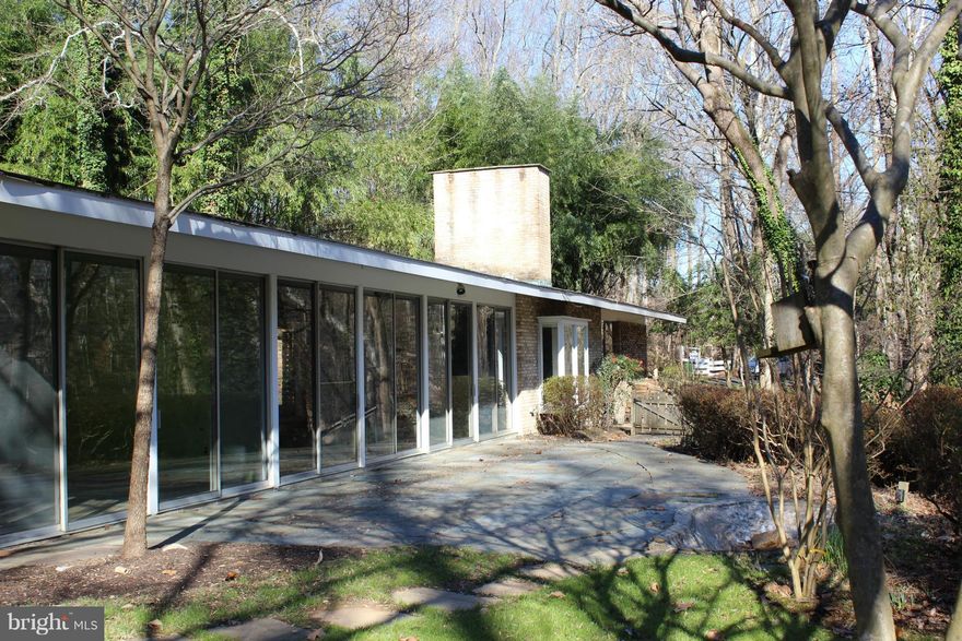 Sun-drenched mid-century modern home sited on 2.9 acres overlooking 4+ acres of parkland. The home boasts nearly 4,000 SF of living space with 5BR/4FB, large living area featuring cathedral ceiling w/skylights, slate flooring, banks of sliding doors overlooking property, and an amazing fireplace.  Remodel of build your dream home!