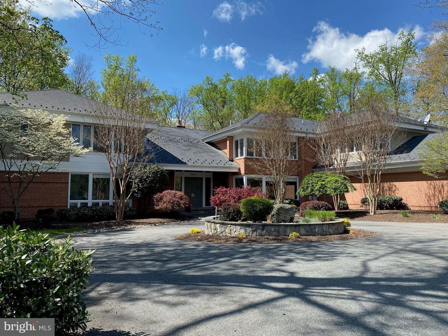 *NEW PRICE*! Welcome to this exciting custom contemporary home set on 2 luxurious acres of custom landscaping.  Designed with dual master suites, one on the main level, and one on the upper level, this floorplan is perfect for multi-generations.  Thoughtfully designed with swimming pool, gazebo, play-yard, and outdoor kitchen/grill area.  High ceilings abound with views from every room to the outdoors.  The main level welcomes you with double doors into a spacious living room with fireplace, formal dining room, expansive family room leading to the large eat in gourmet kitchen complete with breakfast room and expandable glass breakfast table.  The main level hallway leads to a separate master suite with sitting room and masterbath.   Multiple doors lead to the wrap around deck which overlooks the pool area and gazebo.   The second level is designed with a second master suite, with sitting room, masterbath, plus three additional bedrooms with ensuite baths, and a reading nook/homework/library room.  The lower level includes a pool table room, recreation room, two gyms/exercise rooms, a maids room and full bath plus hallway powder room. The second gym room could be a large seventh bedroom or staff bedroom.  The lower level is daylight walkout to the pool and spa area. Adding to the thoughtful amenities are three garages which provide 5 car garage parking on the side of the home.   A circular driveway leads you to the front entry.   This home offers a total of 6 to 7 bedrooms, fabulous entertaining spaces indoors and out, with the privacy of a beautifully landscaped and treed two acres alongside the TPC at Avenel Golf Course.