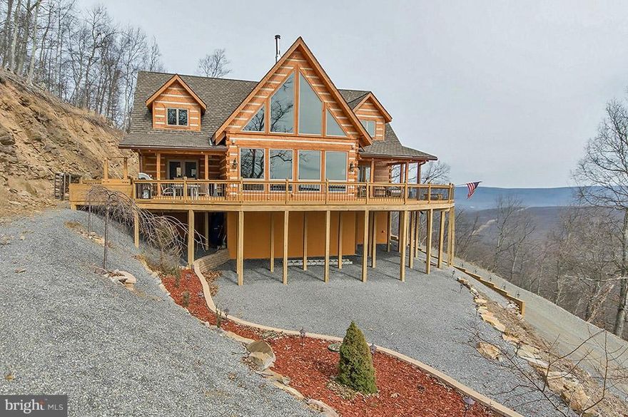 Soar with the Eagles! Spectacular Stone Mill Log Home takes in long range mountain views, majestically perched on 11.81 acres. Owners suite with Jacuzzi tub, two additional private suites, expansive great room, wet bar, gourmet kitchen, granite counters, rec room, office, custom stair case, radiant heat floors, are just a few of the options in the exquisite home. Adjacent to the Avalon Resort!