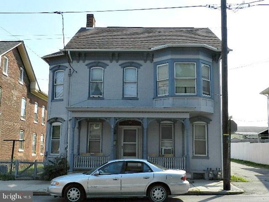 All brick Detached 2 unit located on a corner lot in Hanover Boro. Off street parking for 8+ cars. 1st floor unit is rented w/ EIK, refrigerator & stove, LR, Laundry Rm, bsmt access & a side porch. 2nd floor unit is vacant w/ two Bed Rms, LR, walk-in closet & a full walk up attic. Covered balcony w/ stairs to grade. Separate Elec, Heat, Water, & Hot Water.Tenant takes care of yard and snow removal. Property needs TLC, but has a lot of potential.