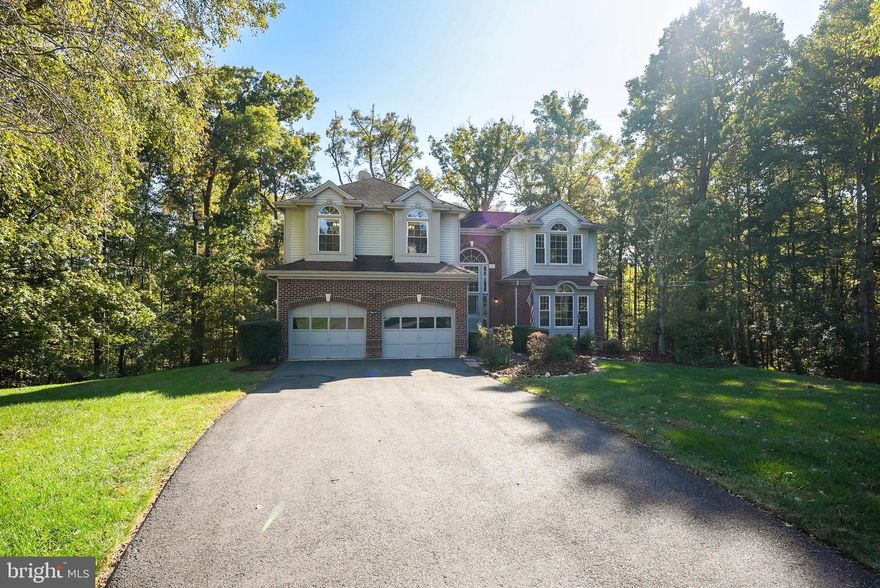 ***SELLER HAS PUT IN A BRAND-NEW ROOF ON 11/18/2024!***
Welcome to 8619 Oak Brook Ln in the sought-after Crosspointe community! This 5-bedroom, 4.5-bath brick-front colonial is nestled on a quiet cul-de-sac with a private, tree-lined backyard. Offering almost 4,500 sq. ft. of living space, this home is perfect for both relaxation and entertaining. Step into the bright two-story foyer with its elegant curved staircase. The updated kitchen features granite countertops, a center island, and brand-new stainless steel appliances. The family room with vaulted ceilings and a brick fireplace creates a cozy atmosphere. The deck off the kitchen offers a peaceful spot for outdoor dining, with serene views of the wooded yard. The home has been refreshed with new interior paint, new windows (2017), and a remodeled master bath, hallway bath, and half bath (2019). Additional upgrades include a new tankless water heater, washer, and dryer (2017-2018). Upstairs, the primary suite features vaulted ceilings, two walk-in closets, and a luxurious en suite bath with dual vanities, a large 5’x8’ digitally controlled shower. Three more spacious bedrooms and updated baths complete the upper level. The lower level offers a large rec room, a full bath, and an in-law suite with a kitchenette, making it perfect for guests. Living in Crosspointe means access to two pools with an active swim team, miles of scenic trails, and close proximity to Lake Mercer, Burke Lake, and the community pond. Don’t miss your chance to own this beautifully updated home in one of Fairfax Station’s finest neighborhoods!