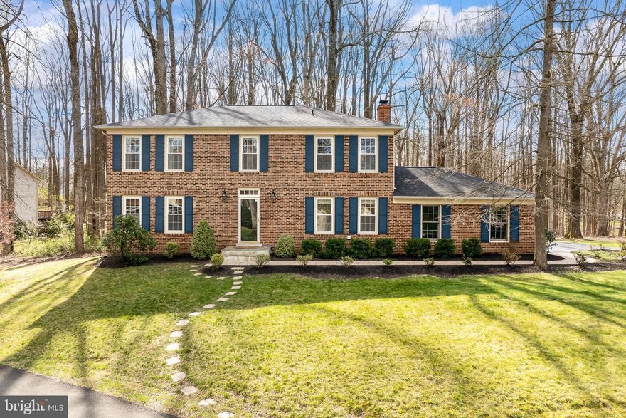 Welcome this stately brick front colonial home to the market. Situated on an almost acre flat lot, framed with majestic mature trees in the heart of Fairfax Station, this home offers a serene and picturesque setting with all the convenience of extensive nearby amenities and commuting options. Boasting over 3,000 sq ft of beautifully updated living space, flooded with natural daylight, this home has 4 bedrooms, 2.5 bathrooms, a finished basement, screened porch and 2 car garage, and is sure to check all your boxes. Step inside where the captivating main level features beautiful Acacia hardwood floors throughout.  A cozy family room with custom built-ins that frame the fireplace, flows seamlessly into the farmhouse style dining room, and continues into the amazing,  thoughtfully laid out gourmet kitchen, that is updated to perfection, and every chef's dream!  
The spacious formal living room provides an intimate space to entertain, while granting access to the wonderful screened porch beyond.  Back inside, a mud/laundry room offers convenience and practicality, while a beautifully updated powder room completes the interior main level. 
Upstairs, the primary suite has an updated bathroom, walk-in closet and secondary closet, providing a tranquil retreat at the end of a busy day.  3 additional bright and cheerful bedrooms share a beautifully updated hall bath, and a huge bonus closet in the hallway provides some great storage.  The lower level is an entertainer's dream, featuring a large recreation room  and plenty of space ready to be customized to fit the needs of the buyer.   
The large lot features a lush, flat backyard enveloped with mature trees creating a natural privacy barrier. 
 The home is elegantly designed and is situated on a superbly graded lot.  Don't miss the opportunity to call this place home! Pool membership available in the neighborhood.  Robinson school pyramid.
TRANSPORT - 25 minutes to Dulles Airport, 20 miles to the Pentagon, 4.4 miles to Burke VRE, 9.6 miles to the Vienna Metro. Easy access to Fairfax County Parkway, Ox Road, 495 and I-66.
Welcome Home!