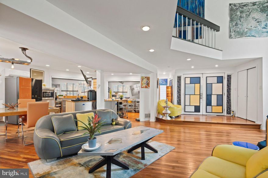 Architectural Elegance Meets Artistic Inspiration

Discover a rare retreat where architectural innovation, inspired by Frank Lloyd Wright, blends seamlessly with modern luxury and artistic vision. This custom-designed mid-century residence, crafted by architect Walter J. Magill, offers an extraordinary fusion of design sophistication, creative energy, and purposeful functionality.

Today, the home serves as much more than a residence. It is a vibrant sanctuary for internationally acclaimed artists and creative communities from New York City and Philadelphia. Functioning as a home, event venue, professional art gallery, and broadcast-quality recording studio, the property provides a dynamic and inspiring environment. The expansive wall space is ideal for curators, collectors, and visual artists to showcase large-scale works, making this a truly expressive and versatile setting.

From the moment you enter, you’re immersed in thoughtful architectural detailing: a sunken living room with soaring 20-foot ceilings, two beveled fireplace walls that dramatize vertical space, graceful archways, a sculptural rounded centerpiece column, and custom curved walls upstairs that evoke the home’s fluid, almost liquid architectural flow. These elements are grounded by hand-selected Brazilian teak wood floors, prized for their resilience and beauty, and framed by exposed high-contrast ceiling beams for an added artistic edge.
The gourmet kitchen is equally impressive—both a culinary workspace and a performance-ready stage. It’s outfitted with professional-grade appliances, including a Thermador microwave, a Dacor stove, and a professional series KitchenAid double oven and dishwasher. The kitchen has hosted art auctions, private concerts, and notable fundraising chef-table experiences. The Samsung's interchangeable color-paneled fridge (extra sets included), paired with Murano glass handles from a Venetian artisan collection, and remote-controlled kitchen blinds to fine-tune natural light and privacy.

The open-concept main level is filled with natural light, enhanced by top-of-the-line Bali blinds with versatile top-down/bottom-up functionality. Upstairs, you’ll find four spacious bedrooms plus a dedicated laundry. The primary bedroom offers exceptional storage with two large walk-in closets and an additional floor-to-ceiling 8-foot-long mirrored closet. Two of the other bedrooms also feature mirrored closet doors, expanding light and visual space.

Other interior highlights include three modern gas fireplaces, a refinished yellow whirlpool tub designed for multi-person use, electronic Mitsubishi split systems in all bedrooms, the kitchen/dining area, and the music studio, as well as a two-zone central HVAC system and full wall insulation for low utility costs and customizable comfort.

The walk-out basement is a creative haven like no other, featuring a fully insulated, broadcast-quality music recording studio, a professional art gallery with museum-grade lighting, and a private guest or in-law suite with a full kitchen, bath, and living space. It includes two separate entrances and access via a circular driveway that accommodates up to eight cars.

Outdoor living is equally versatile, with two thoughtfully designed patios. A cozy elevated patio off the living room is perfect for quiet mornings or evening unwinding, while a spacious garden-level patio is ideal for cookouts, gatherings, and open-air dining. Complemented by Italian-inspired lawn lighting on a timer, the exterior ambiance transitions beautifully into evening. The driveway was repaved in 2023, and the property also includes a substantial barn with endless potential—as a studio, gallery, performance space, or workshop.
The prime location is just a 10-minute walk to the train station, with only two stops to Center City, a 10-minute drive to Trader Joe’s, Whole Foods, and Target and only a 5-minute walk to a newly developed creekside walking and biking trail.