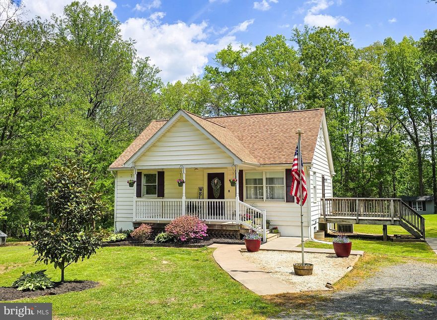 Welcome to 6235 Scottsville Rd—a beautiful Cape Cod perfectly set on a picturesque 1.89-acre (with both lots) in the heart of Jeffersonton. Framed by mature Red Oak and Tulip Poplar shade trees, along with vibrant crepe myrtles, magnolia, and native redbuds, this property offers the kind of peaceful, open setting that is increasingly hard to find.

Inside, the home features a highly desirable layout with a main-level bedroom suite complete with its own en-suite bath and spacious closet—ideal for one-level living or guest accommodations. A second full bathroom on the main level adds convenience, while the front living room offers a welcoming space filled with natural light. The kitchen is both functional and impressive, showcasing a gourmet stainless steel setup with cooktop, upgraded Whirlpool smart double wall ovens, a newer refrigerator, and a stylish tile backsplash—all thoughtfully updated for modern living.

From the kitchen, step out onto the expansive full-width rear deck—perfect for entertaining, grilling, or simply enjoying the quiet surroundings. A secondary side deck (also off of the kitchen) provides additional access to the driveway side and flexibility for everyday use.

Upstairs, you’ll find two generously sized bedrooms, each featuring walk-in closets and abundant, easily accessible attic storage—no ladder required.

The well lit walk-out basement spans the full footprint of the home and offers excellent potential for future finished space, workshop use, or additional storage.

Outdoors, the property truly shines. The open, usable acreage is ideal for gardening, recreation, or simply enjoying the natural beauty. Established perennial landscaping—including hostas and irises—returns year after year, creating a low-maintenance and colorful landscape. Three detached storage sheds provide added versatility, including one outfitted with a deluxe chicken coop and run.

Significant updates and improvements include: Roof 2018, flooring (2018), cabinets (2018), tile showers (2018), tankless instant hot water (2018), concrete sidewalks (2018), furnace replaced (2019), firepit installed (2019), deluxe coop with run and lofted barn-style shed added (2019), kitchen updates including backsplash and microwave/vent hood (2021), whole-home water softening and filtration system (2023), Kohler commercial-style sink and faucet (2023), refrigerator (2024), Whirlpool smart double oven (2024), washer and dryer (2024), freshly updated bathrooms (2025), upgraded dishwasher and range (2025), well pump replaced (2025), along with refreshed paint and updated lighting and ceiling fans throughout.

The home is also wired for Xfinity cable TV and high-speed internet—bringing modern connectivity to this peaceful country setting.

This is a rare opportunity to own a thoughtfully updated home on a beautiful, usable lot with space, privacy, and flexibility—just a short 20 minute drive to Warrenton, Culpeper, and major commuter routes.