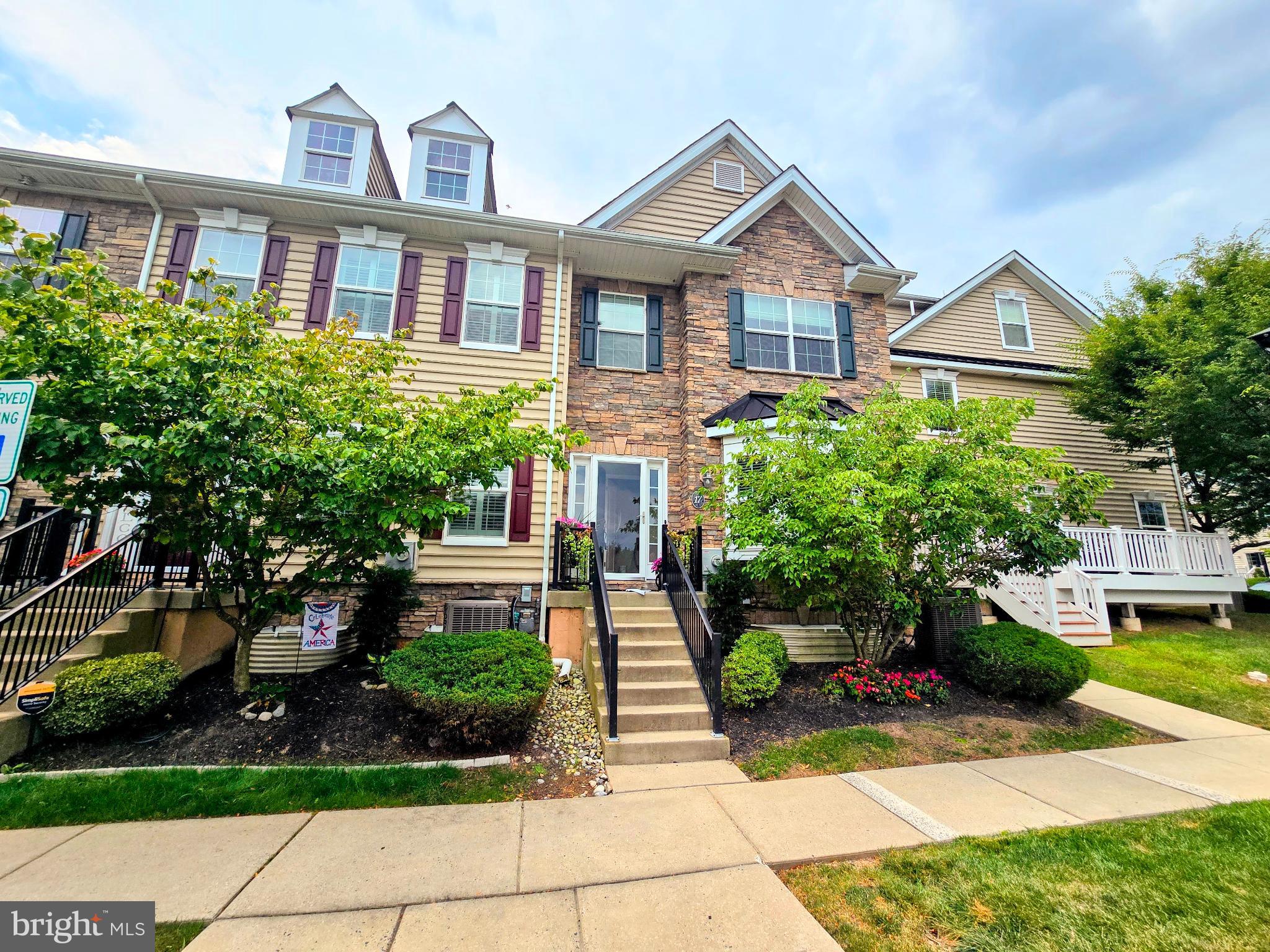 Desirable end-unit townhouse in Carriage Hill just minutes from downtown and top-rated Central Bucks Schools. This stylish 3-bedroom, 2.5-bath home features hardwood and LVP flooring, an open-concept layout, and a fully finished basement offering extra living space. The bright and inviting living area includes a cozy fireplace, perfect for relaxing evenings. The gourmet kitchen includes granite countertops, 42” cabinets, a center island, and a walk-in pantry. Sliding glass doors lead to a private patio, ideal for outdoor dining or relaxation. The spacious owner’s suite boasts a walk-in closet and private bath, while the second bedroom and full bath are conveniently located on the same level. A third-floor loft adds flexible space ideal for a bedroom, office, or guest room. The finished basement includes a large recreation area, laundry room, and additional storage. Enjoy parking and open green space right in front of the home. Community amenities include a park, playground, walking trails, and basketball/soccer courts. With easy access to Peace Valley Park, shopping, dining, museums, and major routes (202, 611, 313), this move-in-ready home is packed with comfort, space, and upgraded style.