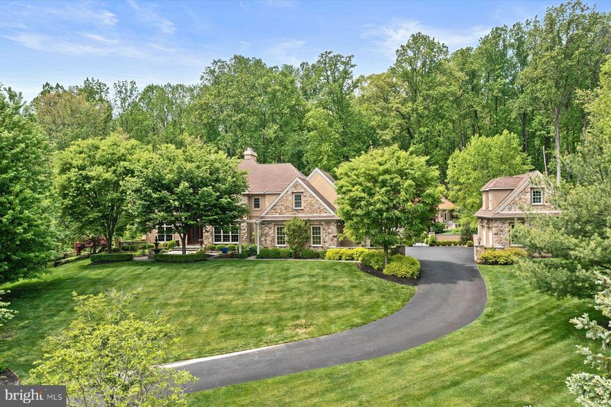 On a quiet cul-de-sac street in the stunning Zaveta Custom Homes neighborhood of Sage Meadows, sits your opportunity for a tranquil & resort-like retreat to call home.  With 5500 square feet of living space on the first and 2nd floor, a finished basement with a bar, wine room, & movie theater, a pool cabana with a full bathroom, kitchen, bar, & woodburning fireplace, and a detached garage with space above that can be finished to your liking, there is no shortage of possibilities on how you can choose to live and use the spaces here.  The first floor of the main house integrates seamlessly with the outdoor living space via French doors in every room, which helps to further the already impeccable flow from the gourmet kitchen to the family room to the entry foyer, living room & dining room – all making for the perfect entertaining floorplan.  The natural separation from the main traffic flow areas of the at-home office, with its handsome built in cabinetry, and the brightly lit expansive sunroom, make these rooms ideal for your exclusive and private use.  The 2nd floor of the home boasts a comfortably sized primary bedroom with walk-in closets, a sitting room, & bathroom with a large walk-in shower & soaking tub.  The three additional bedrooms on the 2nd floor are flooded with natural light for a bright and airy feel, and all have en-suite bathrooms with nicely sized closets.  The walk-out lower level has a bedroom with a full bathroom and is complete with French doors leading out to a lower patio with a view of the cascading waterfall from the saltwater pool.  The pool cabana, along with its attributes listed above, was built in 2015 with two sides of accordion doors to allow for an outdoor feel while maintaining the opportunity to escape the sun or weather as you enjoy the outdoor space.  A truly impeccable home with outstanding finishes and very smart uses of space; all while being located less than 10 minutes to New Hope’s downtown, 35 minutes to Princeton, 45 minutes to center city Philadelphia, & 90 minutes to New York City.