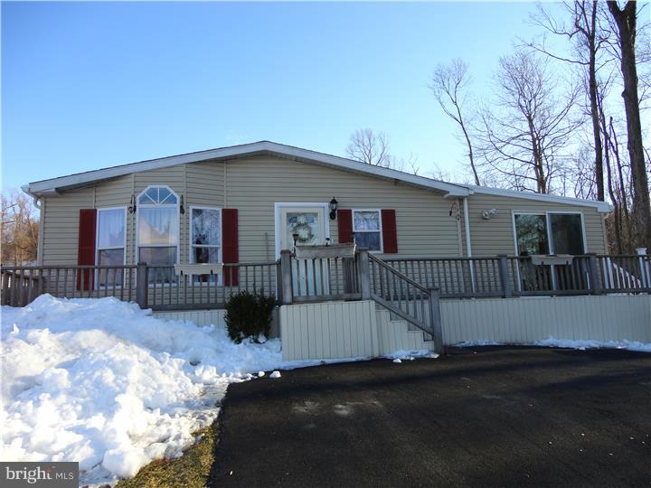 A fabulous sun filled double wide located on the best lot in the beautiful 55+ park, under 55 will be considered but no school aged little ones permitted to live here. This is an oversized 28' x 44' Pine Grove home has a recently added $25,000 23' x 12' sunroom addition with tile floor, recessed lighting and lots of windows to enjoy your views. This easy one floor living home boasts a private setting found at the end of a quiet road that will not disappoint when you come home after a busy day. Spacious live in kitchen with an island, new refrigerator and plenty of cabinets. Roomy master bedroom/handicap walk in oversized shower and WI closet. Spacious rooms, ample closet space and open floor plan, 6 ceiling fans, professional landscaping, storage shed and even a new 26" snow blower included. Easy access to major roads and shopping, beautiful country setting in this peaceful quiet neighborhood. Call to see this one.