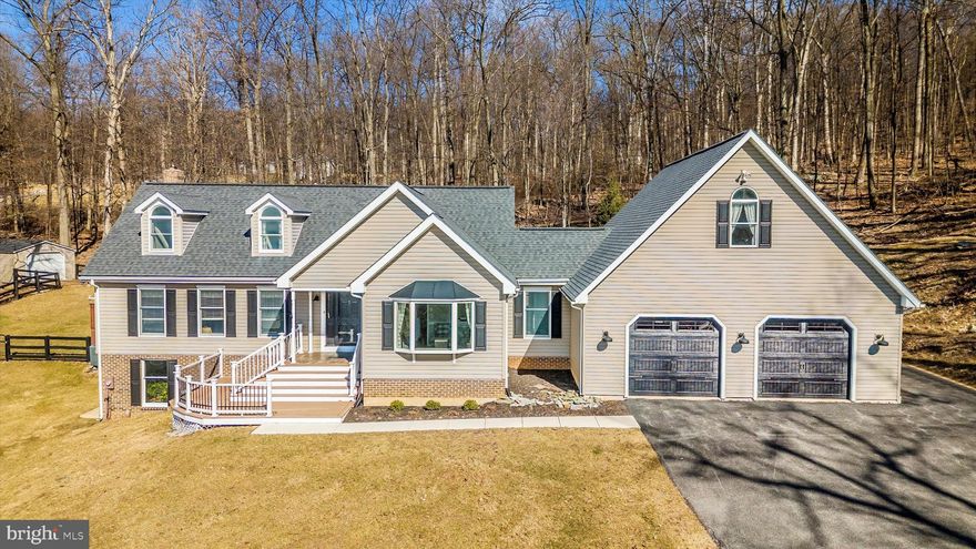 This home is absolutely stunning! From the beautiful interior design to the cozy floor-to-ceiling brick gas fireplace, it truly has everything one could wish for. The open kitchen and great room are perfect for hosting gatherings and creating lasting memories. The primary bedroom with full bathroom is located on the main level.  With the additional living room, office/den, separate dining area, and two more spacious bedrooms, there's plenty of room for everyone to spread out and relax. The walkout level basement is waiting to be finished or use for your workshop and storage.  The oversized 32x32 garage with extra storage and the expansive 4.37-acre property are fantastic bonuses. Enjoy all the outdoor living spaces either on the patio or deck and take in the scenery or the beautiful mountain views. It is a dream home ready to welcome its new owners!